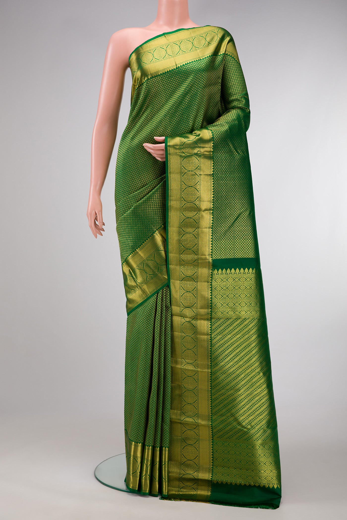 Green Dual Tone Kanchipuram Silk Saree with Zari Brocade on the body and Zari Border.  displayed on a mannequin