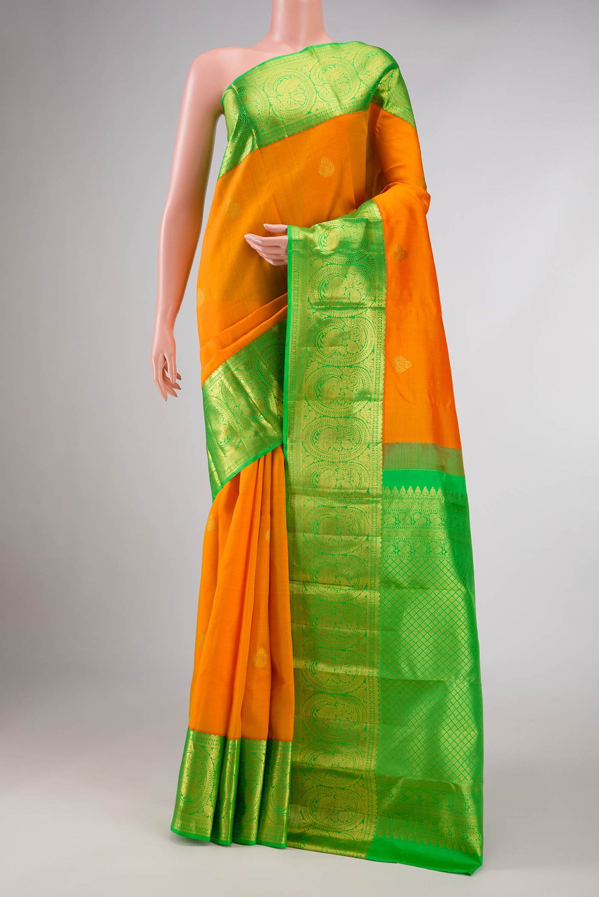 Orange Dual Tone Kanchipuram Saree with Zari Butta on the body and Zari Border displayed on a mannequin