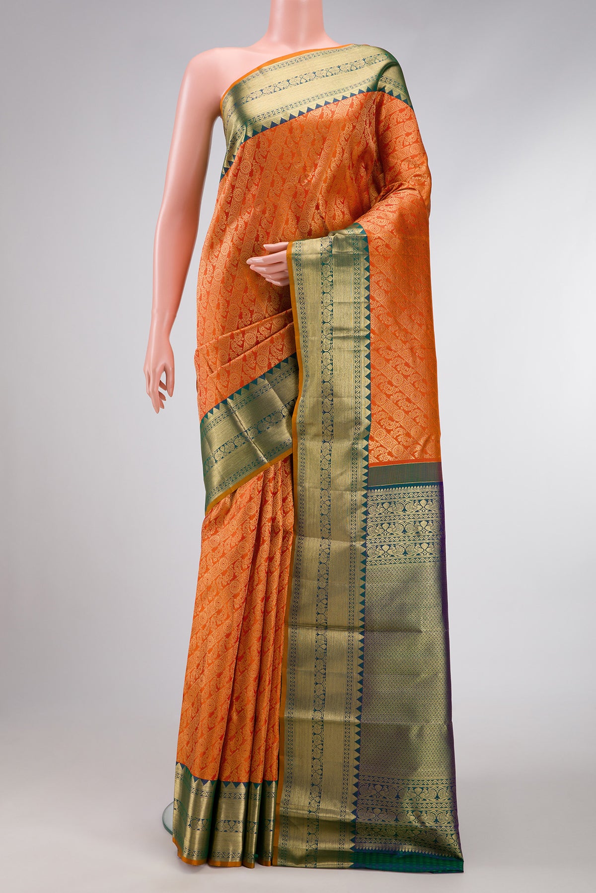 Orange Dual Tone Kanjivaram Silk Saree with Zari Brocade on the body and Zari Border.  displayed on a mannequin