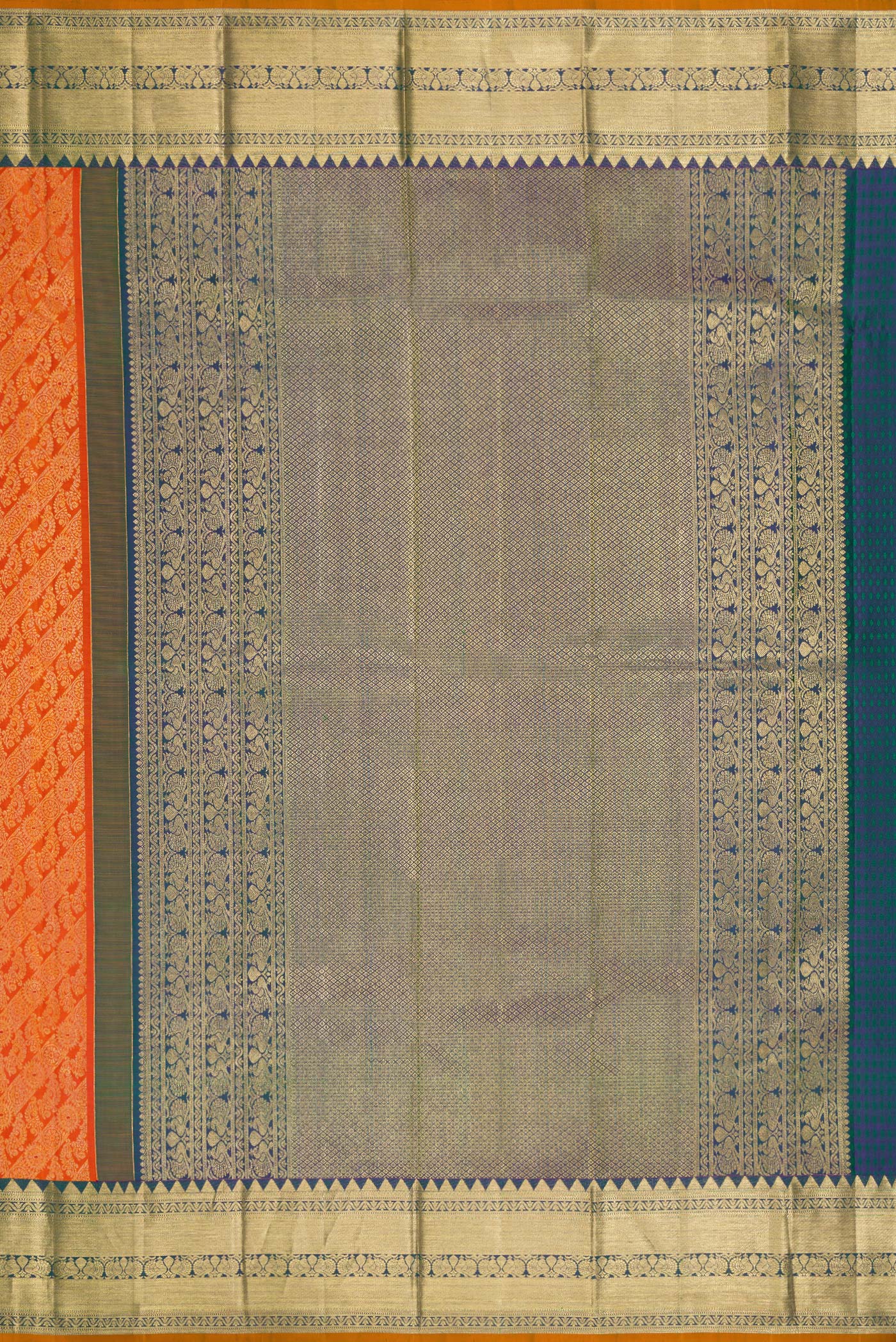 Close up image of the pallu of Orange Dual Tone Kanjivaram Silk Saree with Zari Brocade on the body and Zari Border. 