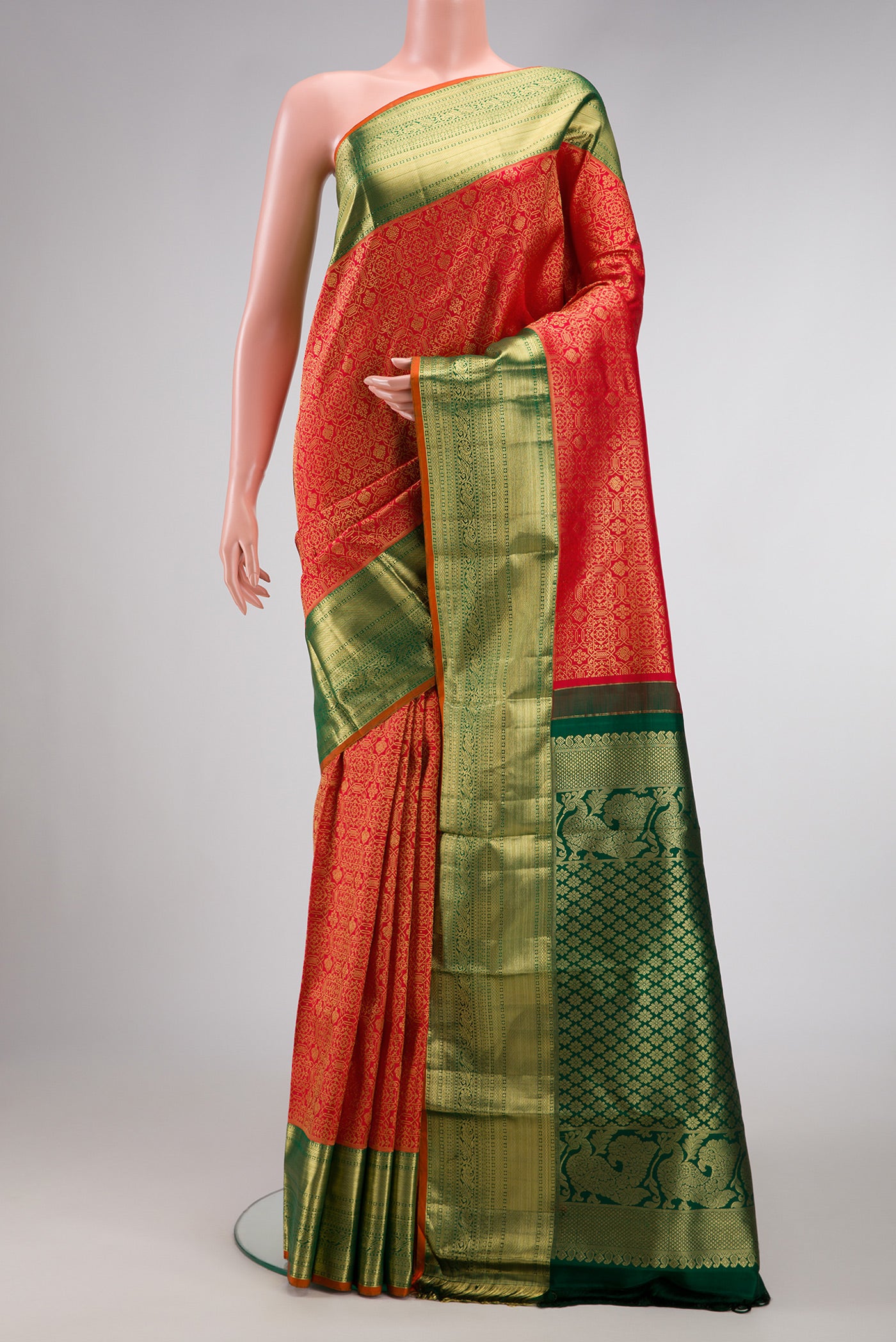 Red Dual Tone Kanjivaram Silk Saree with Zari Brocade on the body and Zari Border.  displayed on a mannequin