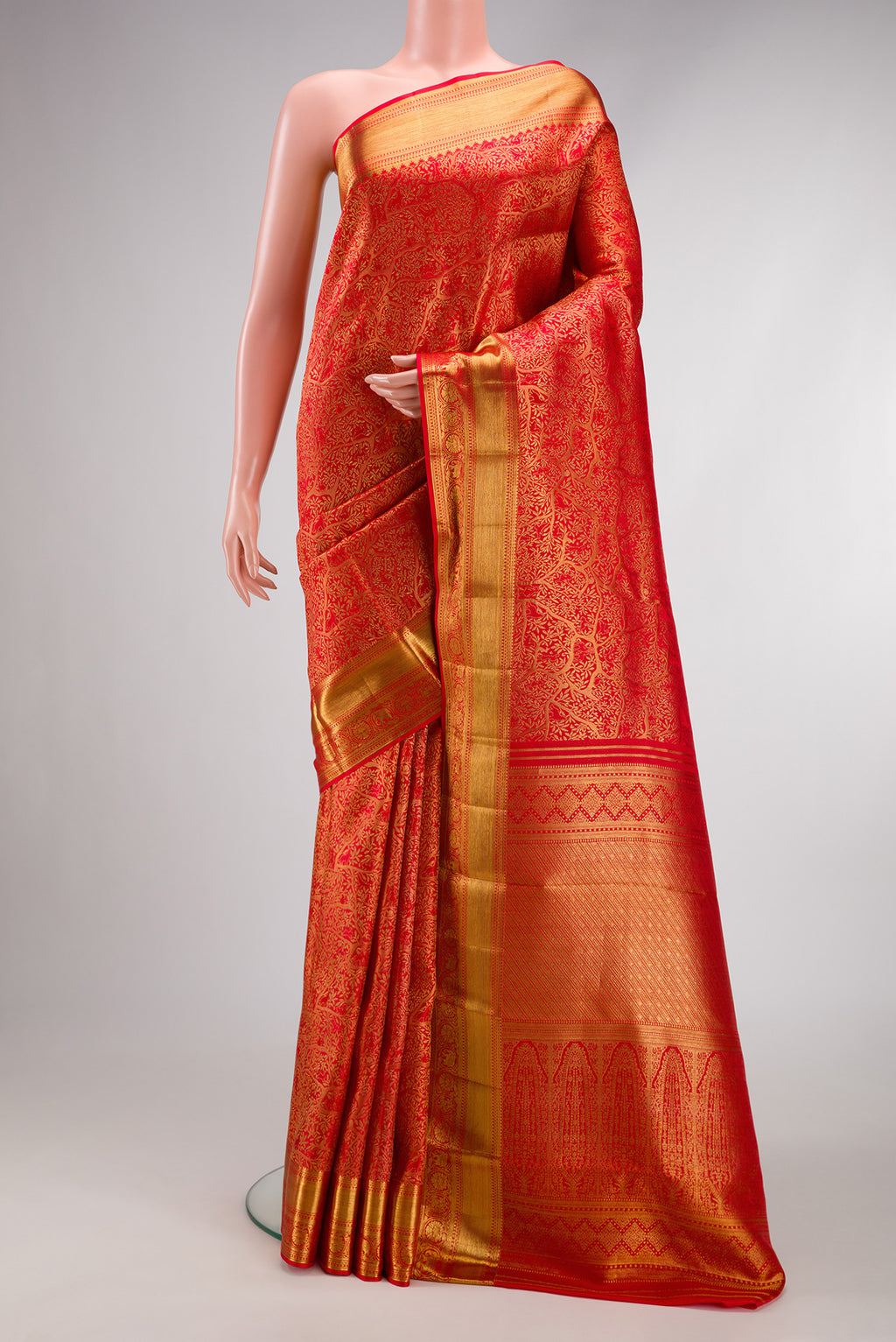 Red Dual Tone Kanjivaram Silk Saree with Zari Brocade on the body and Zari Border.  displayed on a mannequin
