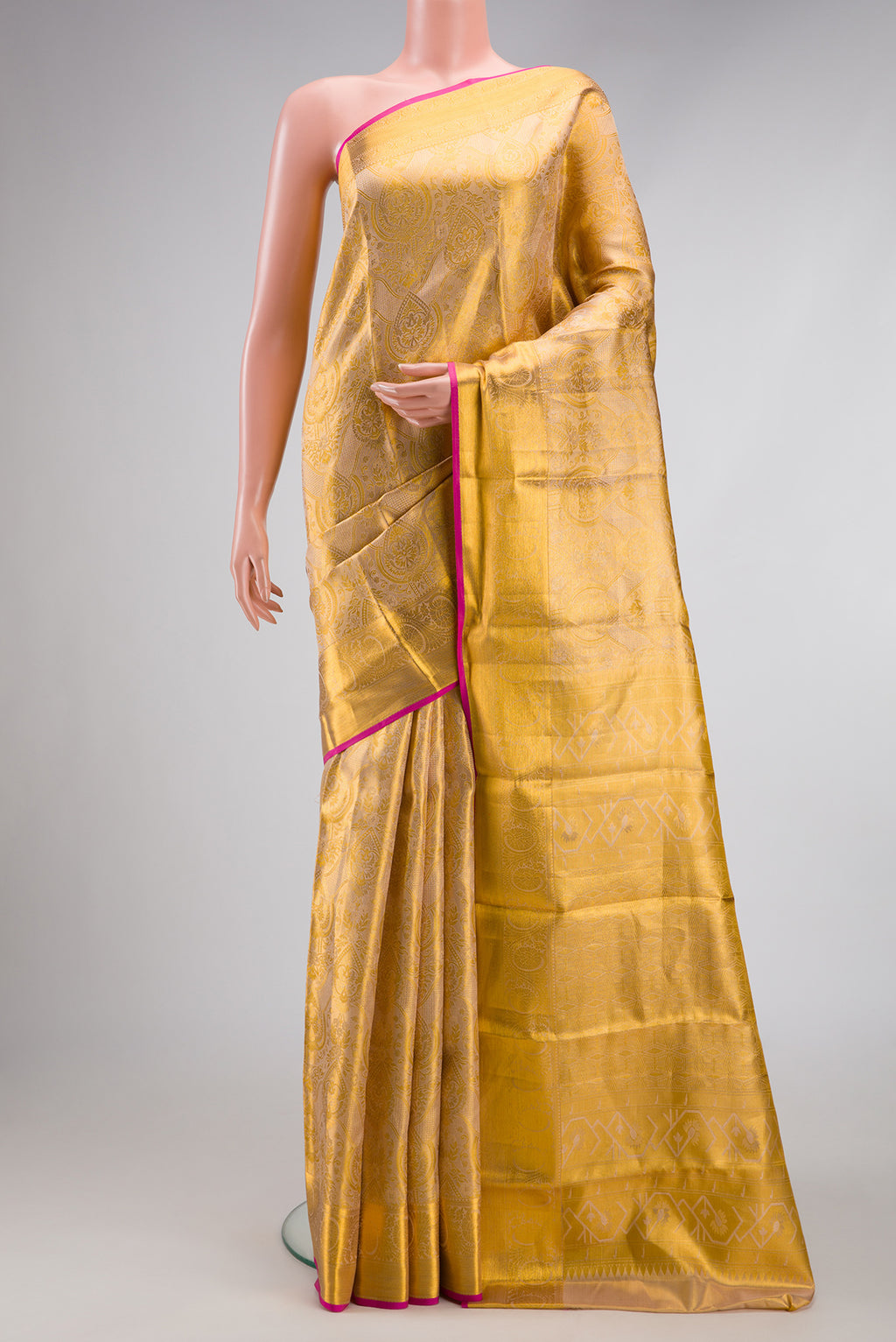 Gold Dual Tone Kanchipuram Tissue Silk Saree with Zari Brocade on the body and Zari Border.  displayed on a mannequin