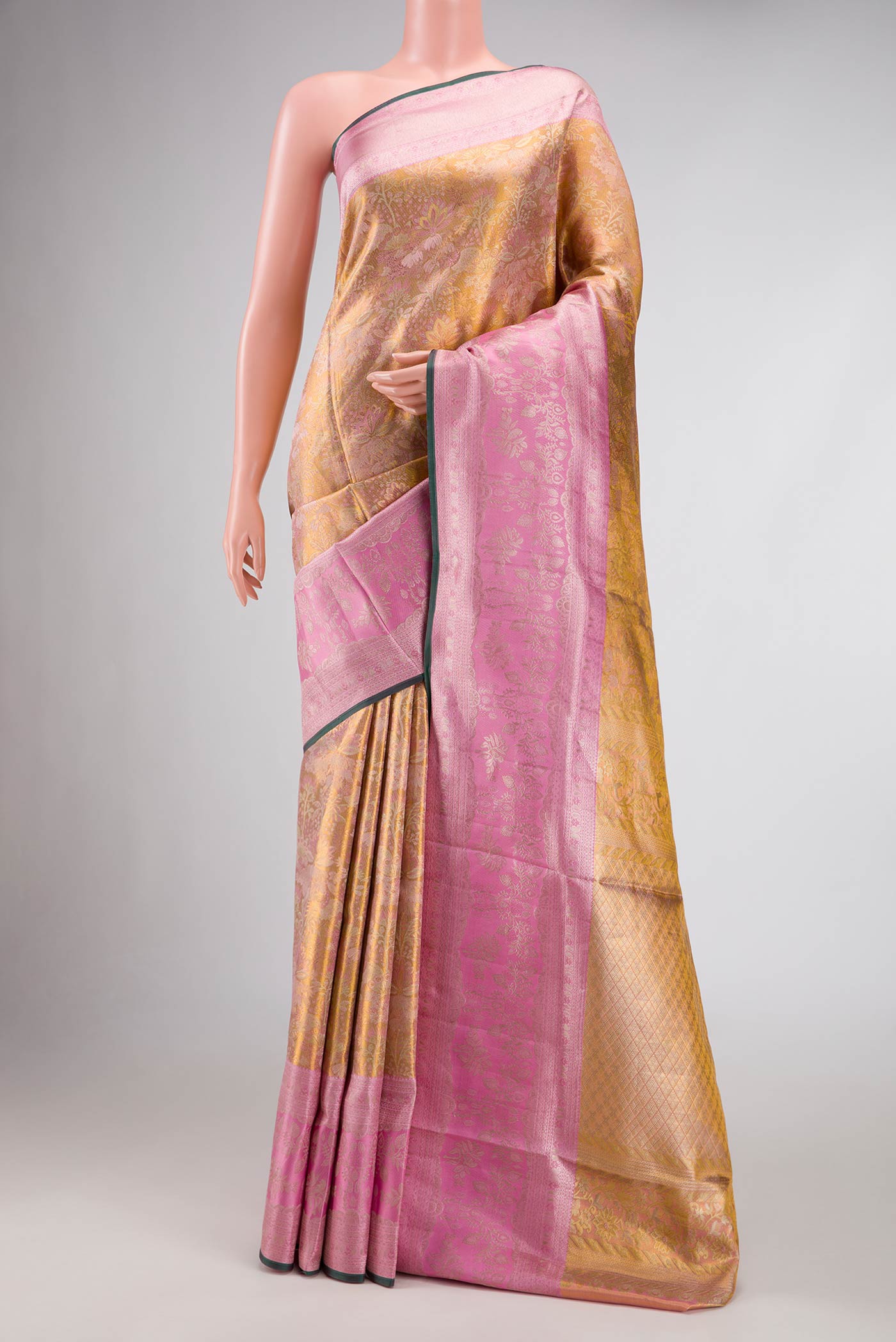 Gold Dual Tone Kanjivaram Tissue Silk Saree with Zari Brocade on the body and Zari Border.  displayed on a mannequin