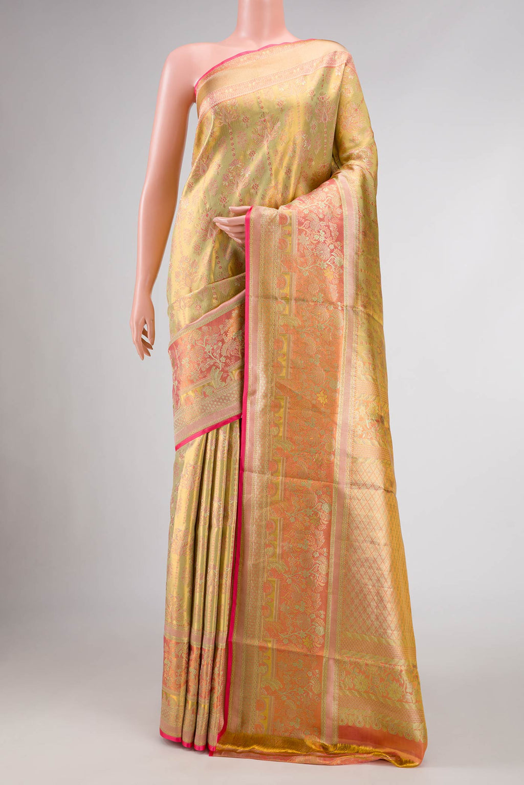 Gold Dual Tone Kanjivaram Tissue Silk Saree with Zari Brocade on the body and Zari Border.  displayed on a mannequin