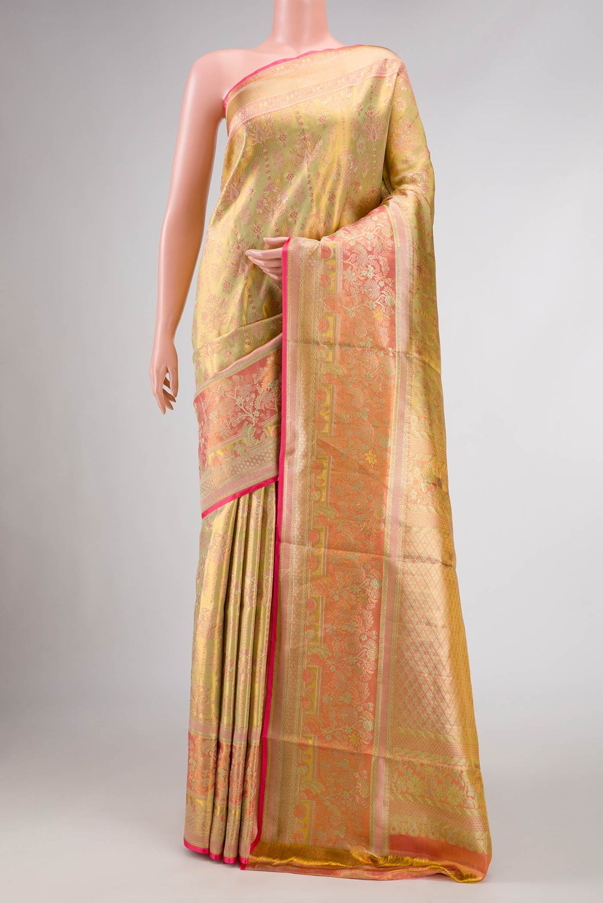 Gold Dual Tone Kanjivaram Tissue Silk Saree with Zari Brocade on the body and Zari Border.  displayed on a mannequin