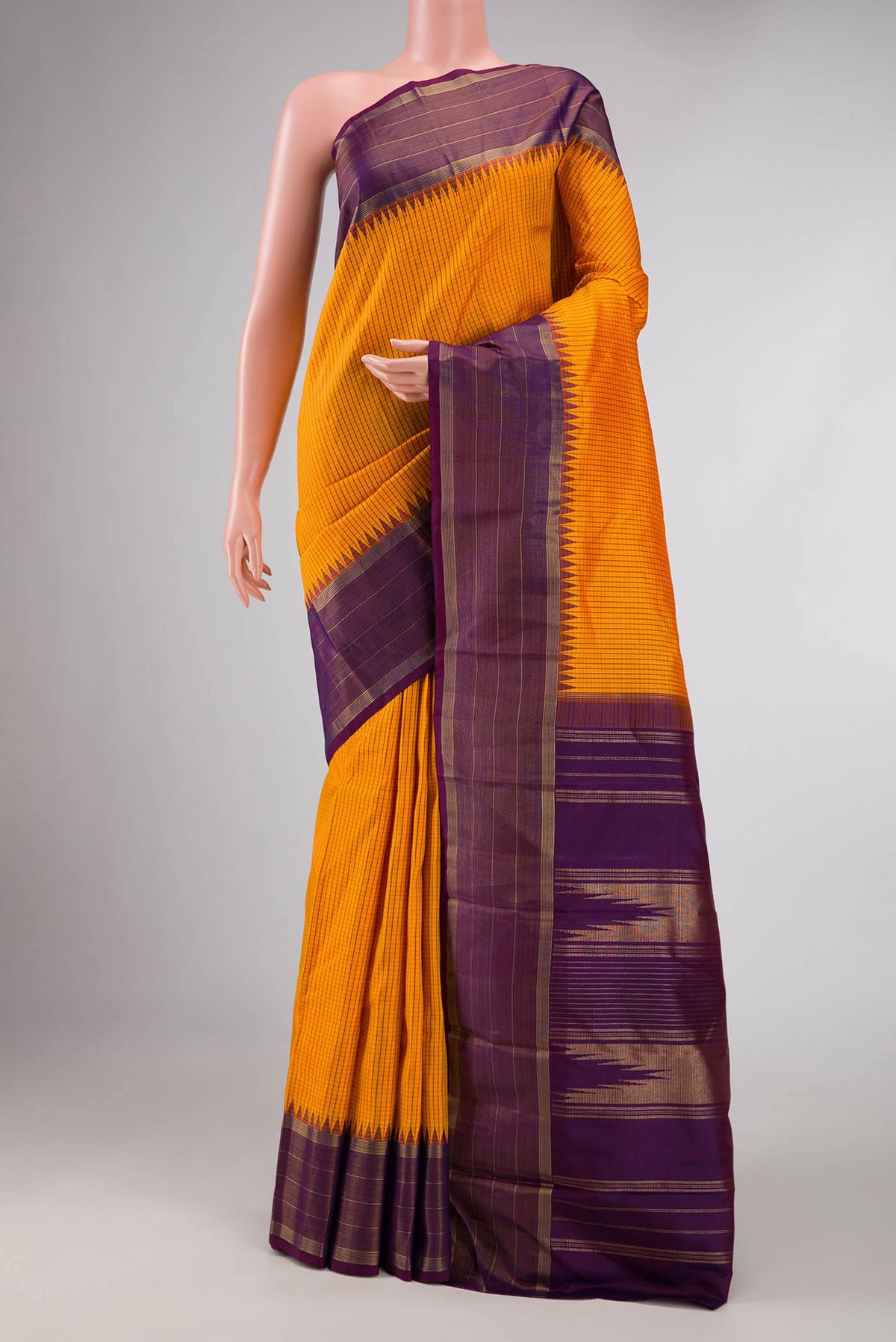Mustard Dual Tone Kanchipuram Saree with Checked design on the body and Zari Border displayed on a mannequin
