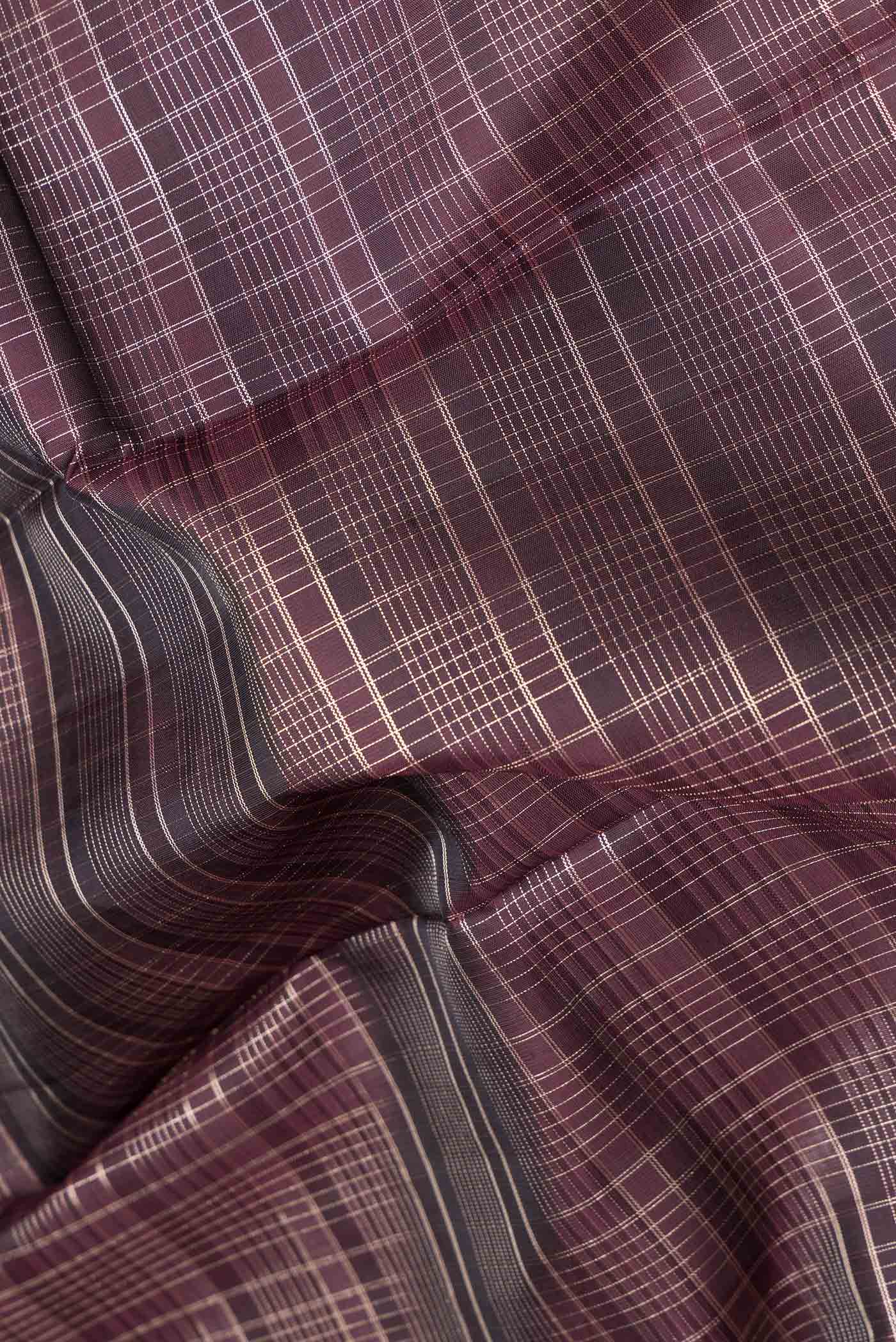 Close up of Coffee Brown Dual Tone Kanchipuram Silk Saree with Checked design on the body and Zari Border.  displaying folds