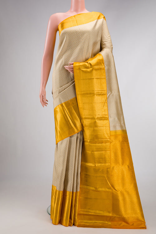 Beige Dual Tone Kanjivaram Silk Saree with Zari Brocade on the body and Zari Border.  displayed on a mannequin