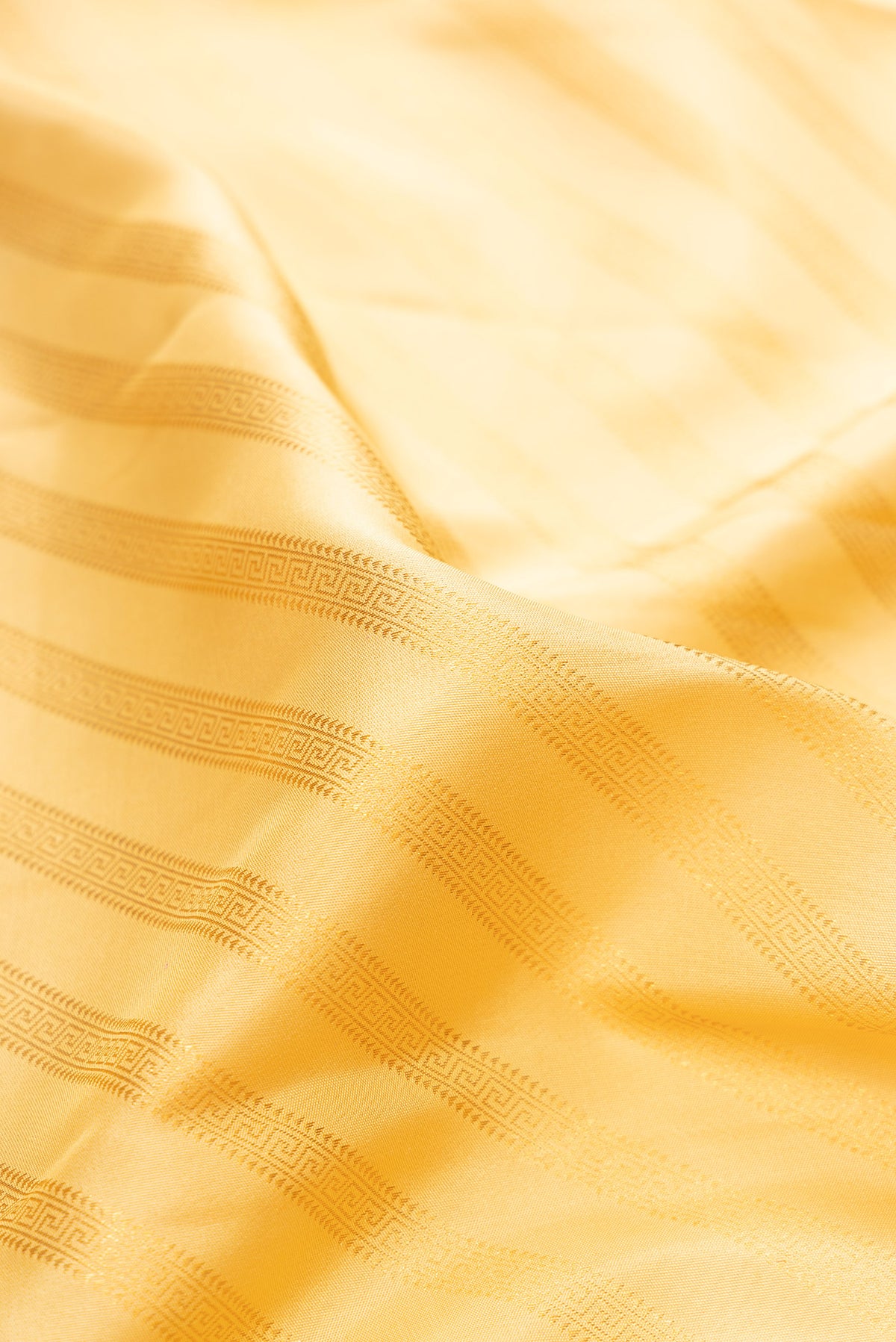 Close up of Pure Silk Sandal Kanjivaram Saree with Stripes on the body and Zari Border.  displaying folds