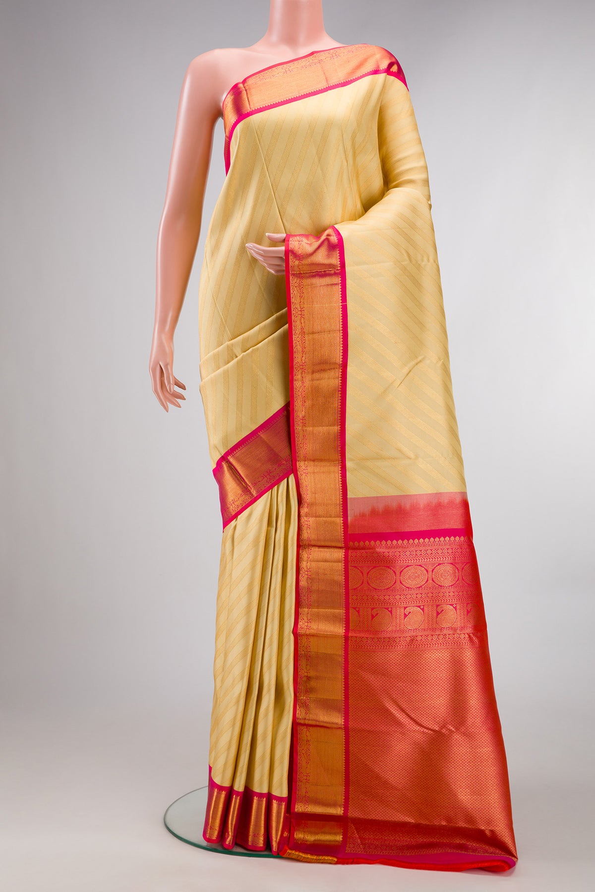 Pure Silk Sandal Kanjivaram Saree with Stripes on the body and Zari Border.  displayed on a mannequin