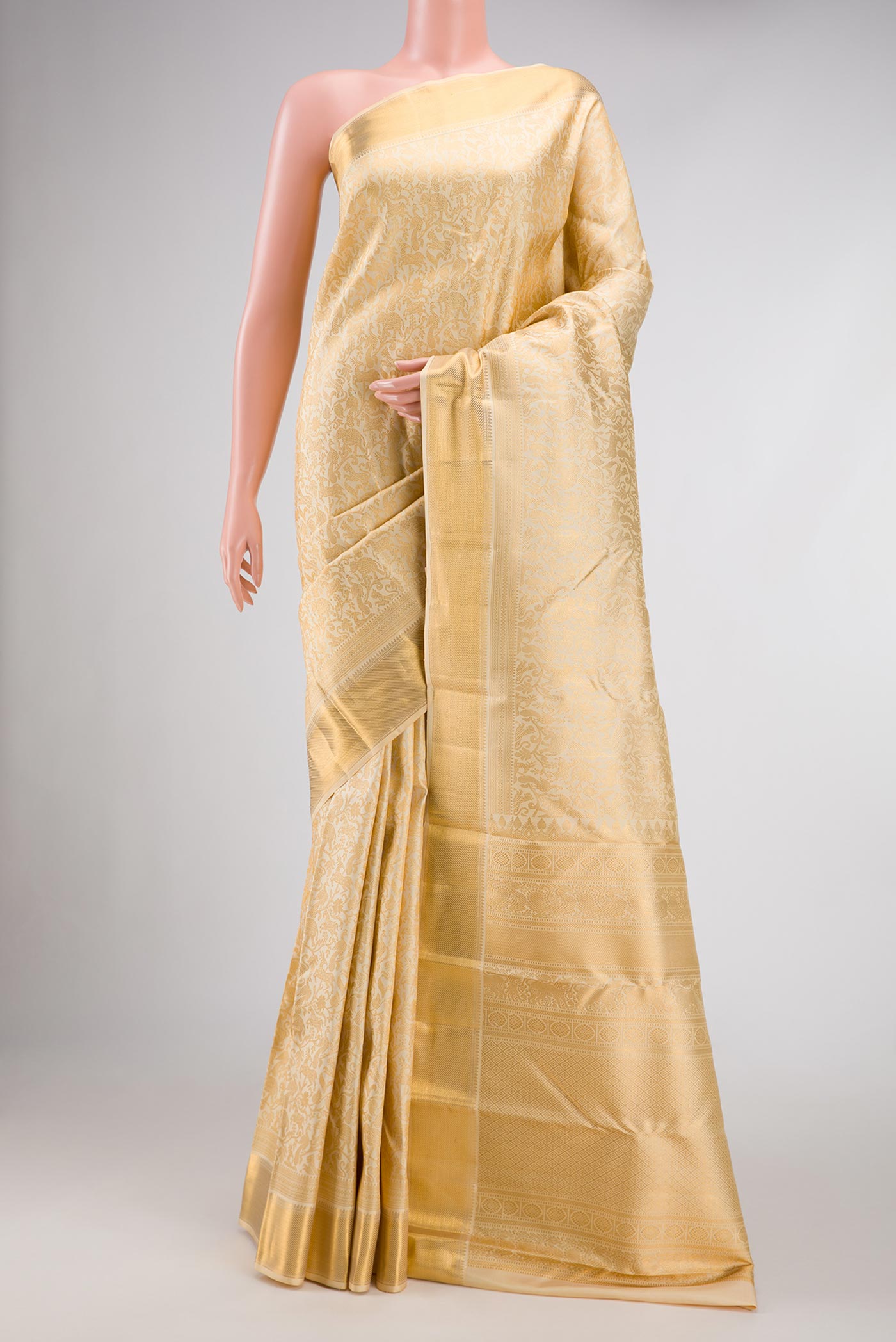 Beige Dual Tone Kanjivaram Silk Saree with Zari Brocade on the body and Zari Border.  displayed on a mannequin