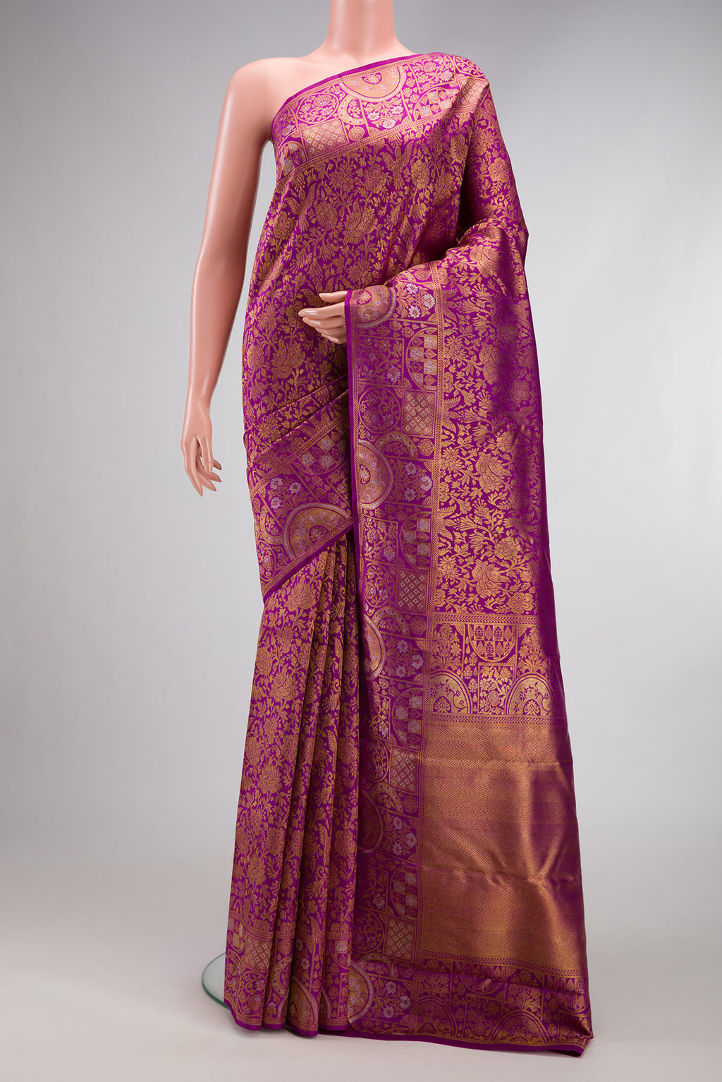 Magenta Kanjivaram Silk Saree with Zari Brocade on the body and Fancy Border.  displayed on a mannequin