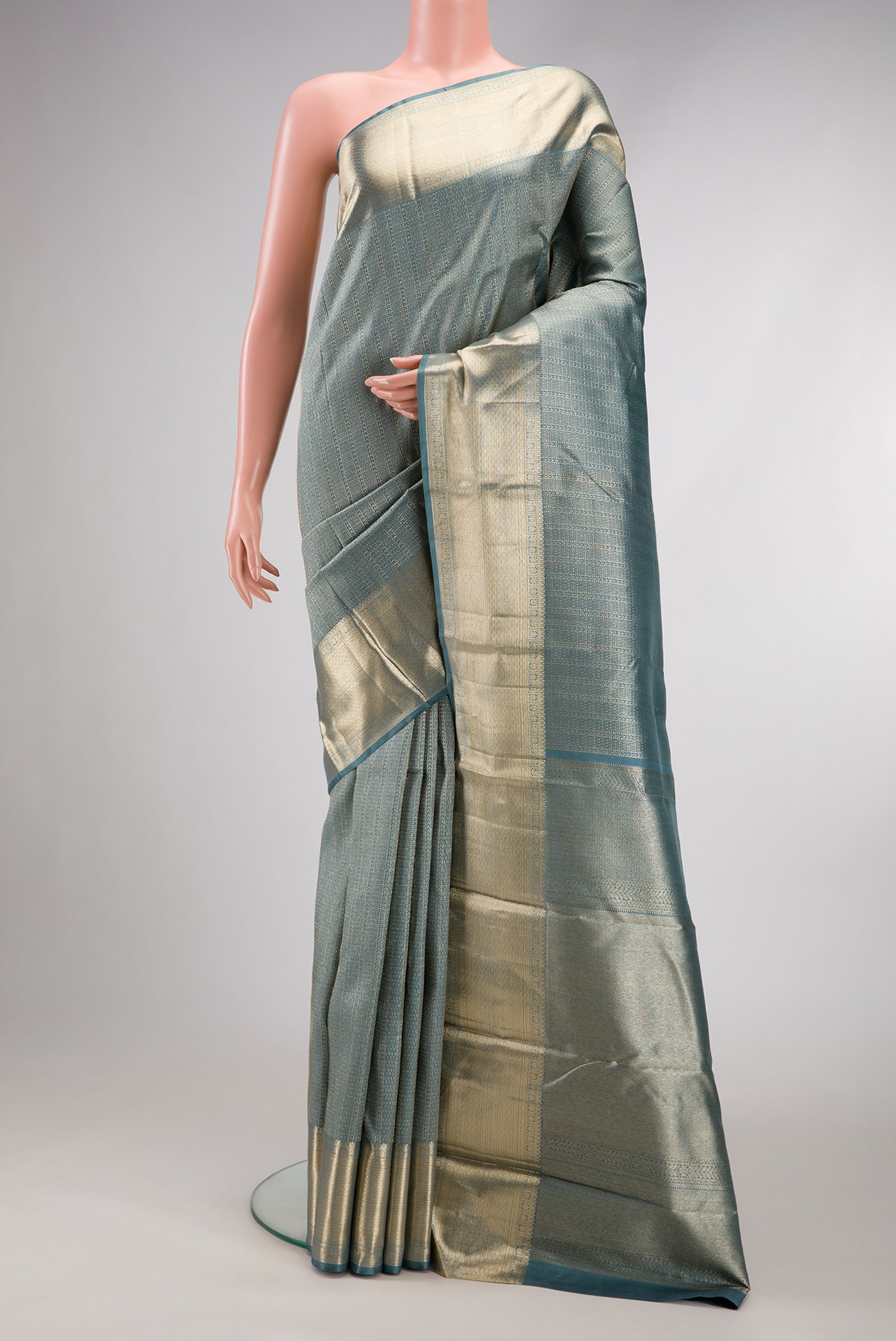 Grey Dual Tone Kanchipuram Silk Saree with Zari Brocade on the body and Zari Border.  displayed on a mannequin