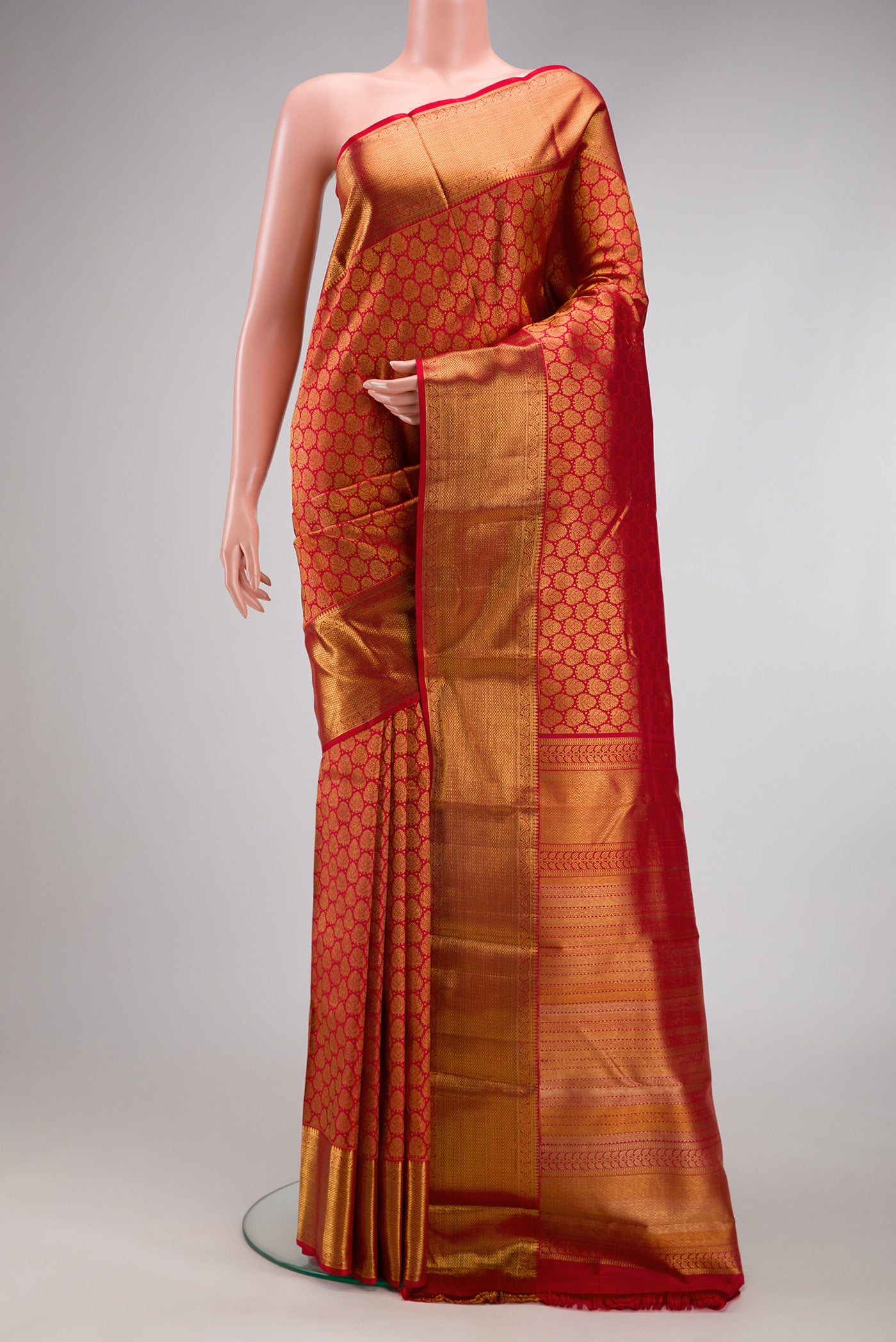 Red Kanchipuram Silk Saree with Zari Brocade on the body and Zari Border.  displayed on a mannequin