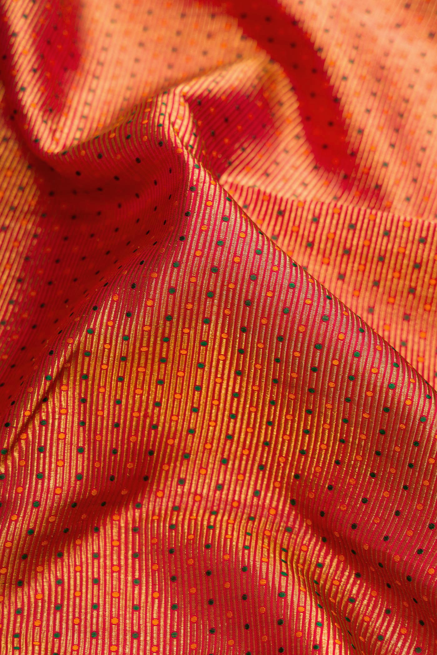 Close up of Red Dual Tone Kanchipuram Silk Saree with Zari Brocade on the body and Zari Border.  displaying folds