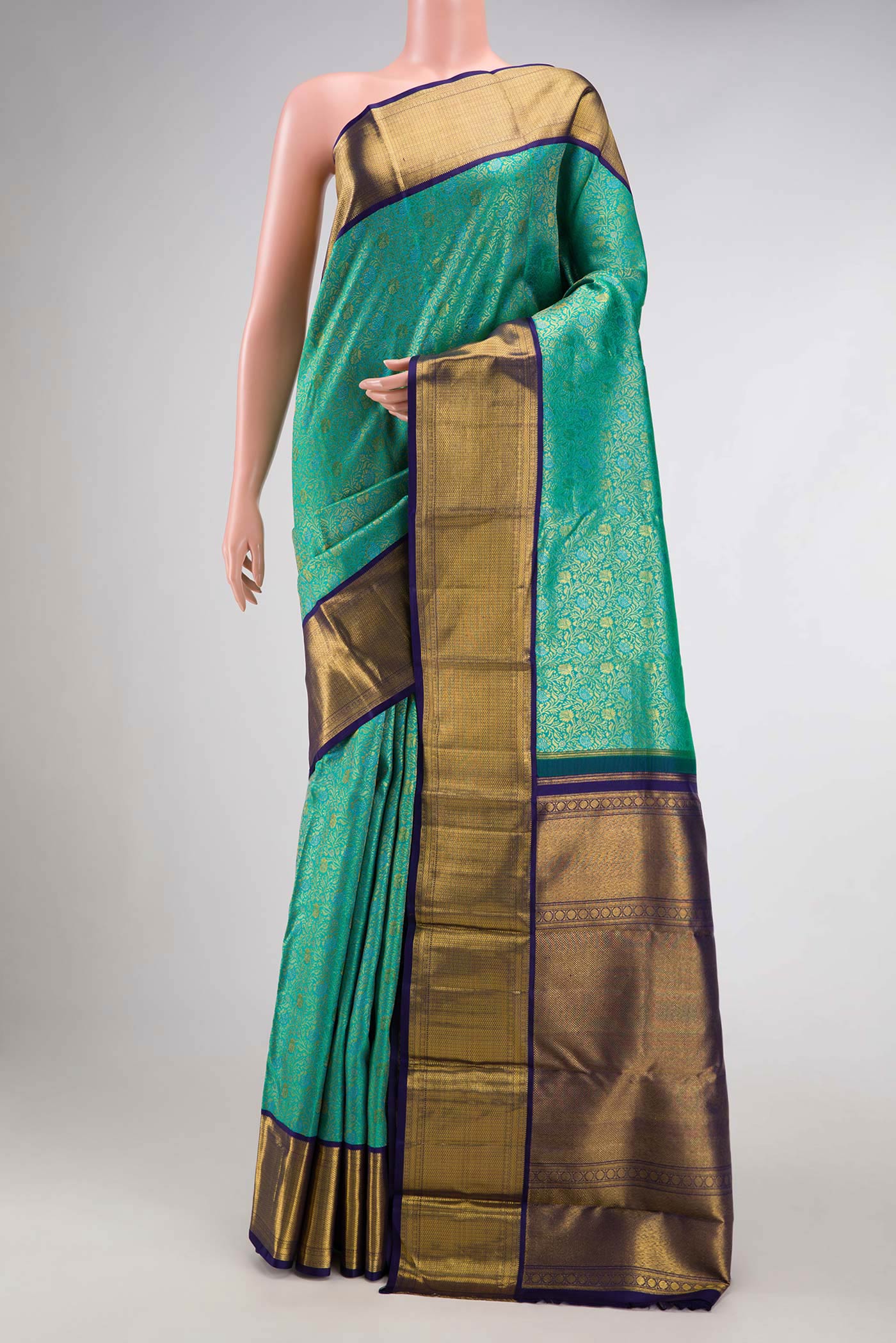 Sea Green Dual Tone Kanchipuram Silk Saree with Zari Brocade on the body and Zari Border.  displayed on a mannequin