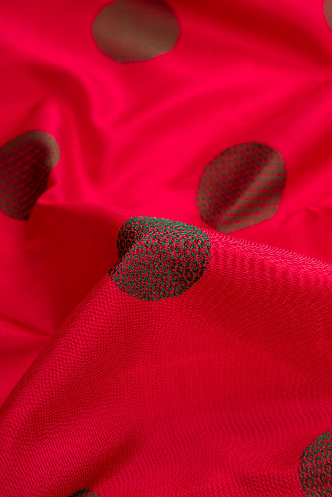 Close up of Pure Silk Pure Zari Red Dual Tone Kanchipuram Saree with Thread Butta on the body and Zari And Thread Border.  displaying folds