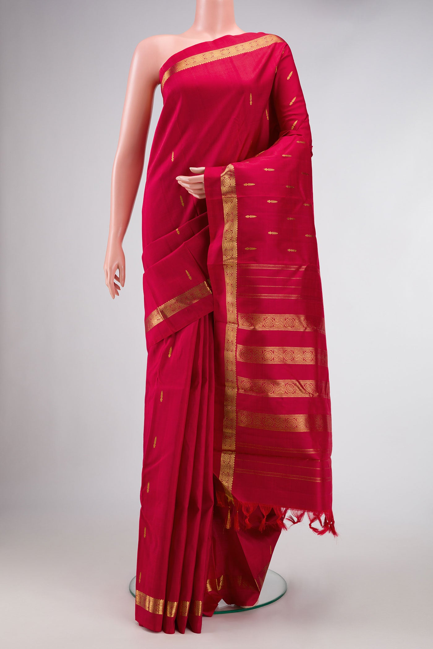 Maroon Dual Tone Kanchipuram Silk Saree with Zari Butta on the body and Zari Border.  displayed on a mannequin