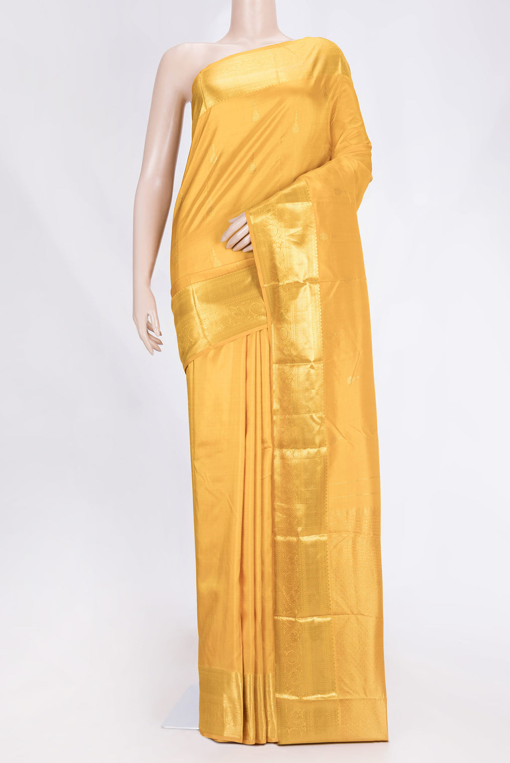 Mustard Dual Tone Kanjivaram Saree with Zari Butta on the body and Zari Border.  displayed on a mannequin