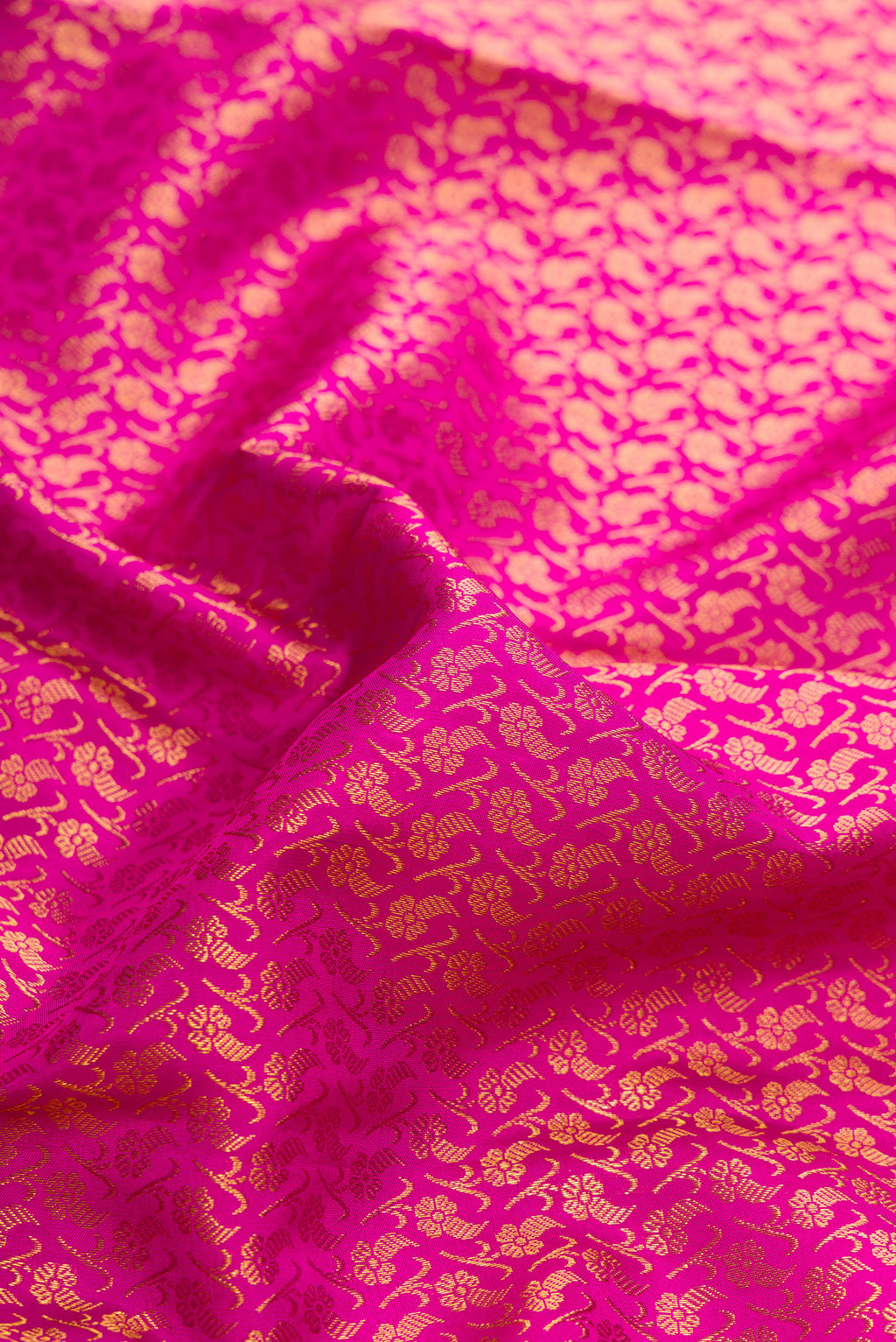 Close up of Pink Dual Tone Kanchipuram Silk Saree with Zari Brocade on the body and Zari Border.  displaying folds
