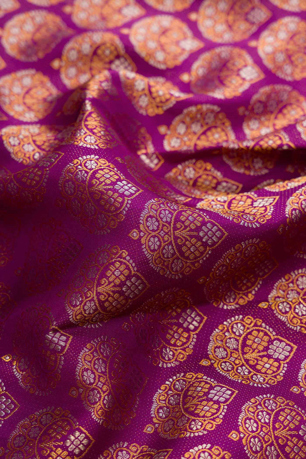 Close up of Purple Dual Tone Kanchipuram Silk Saree with Zari Brocade on the body and Zari Border.  displaying folds