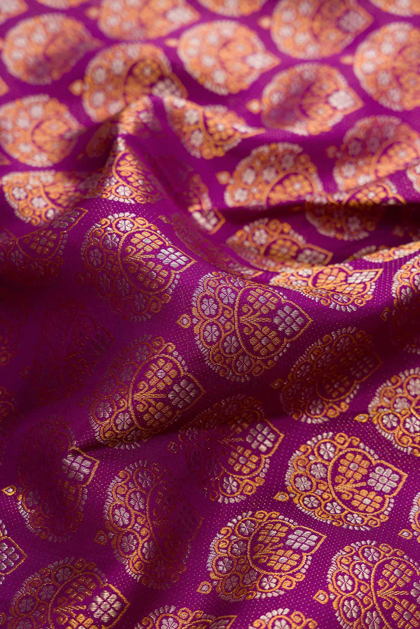 Close up of Purple Dual Tone Kanchipuram Silk Saree with Zari Brocade on the body and Zari Border.  displaying folds