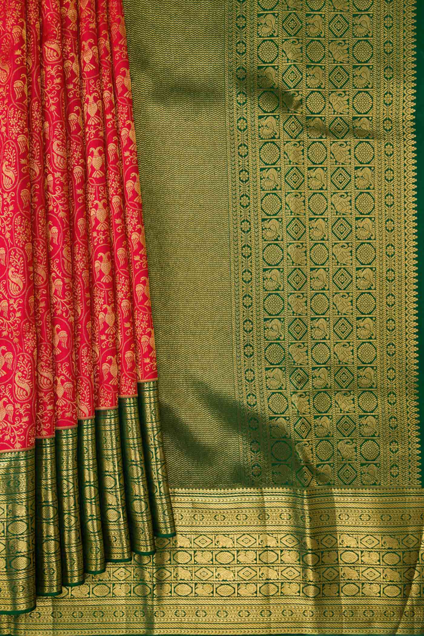 Pleats and pallu of Red Dual Tone Kanchipuram Silk Saree with Zari Brocade on the body and Zari Border. 