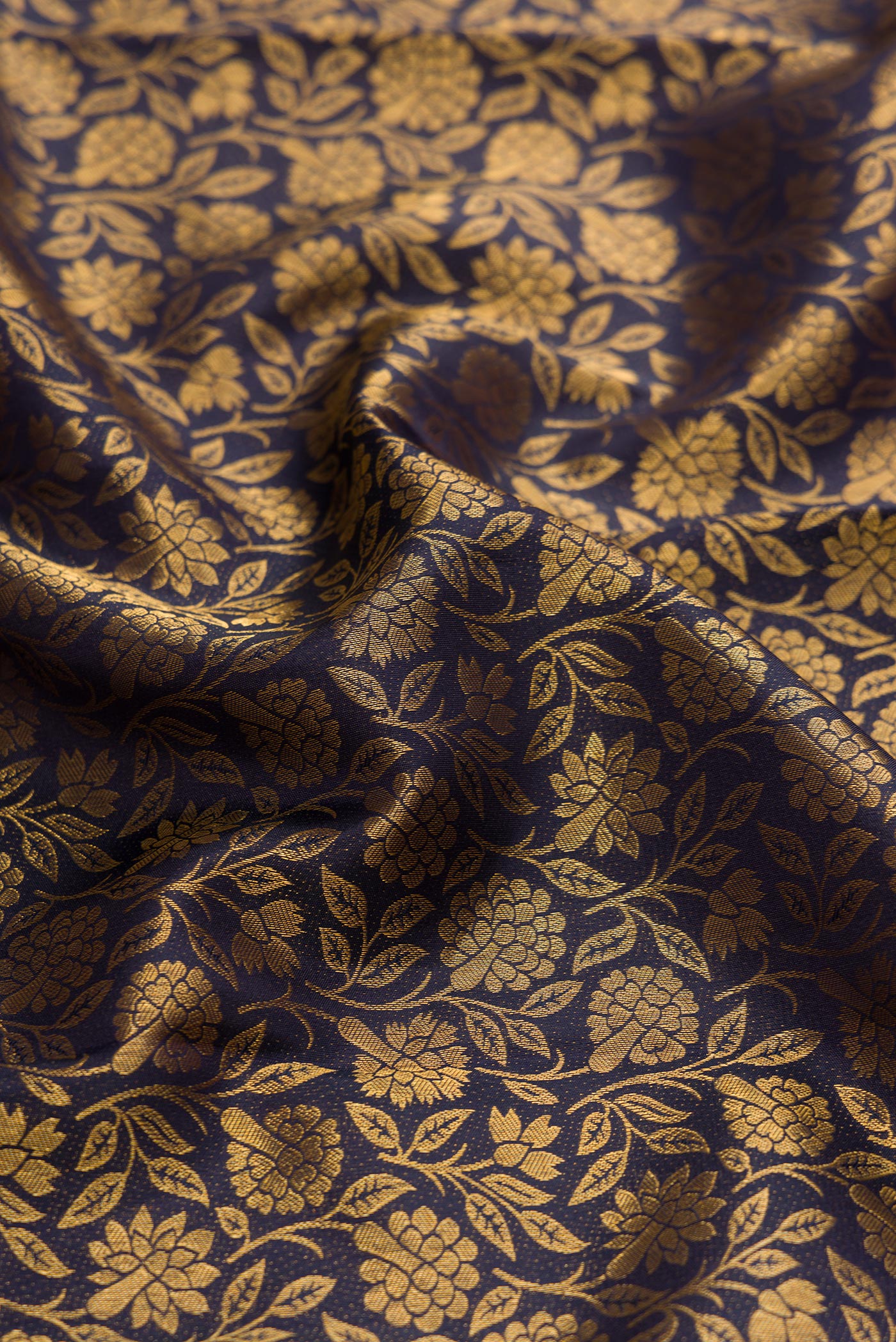 Close up of Navy Blue Dual Tone Kanchipuram Silk Saree with Zari Brocade on the body and Zari Border.  displaying folds