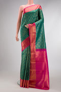 Green Kanchipuram Silk Saree with Zari Brocade on the body and Zari Border.  displayed on a mannequin
