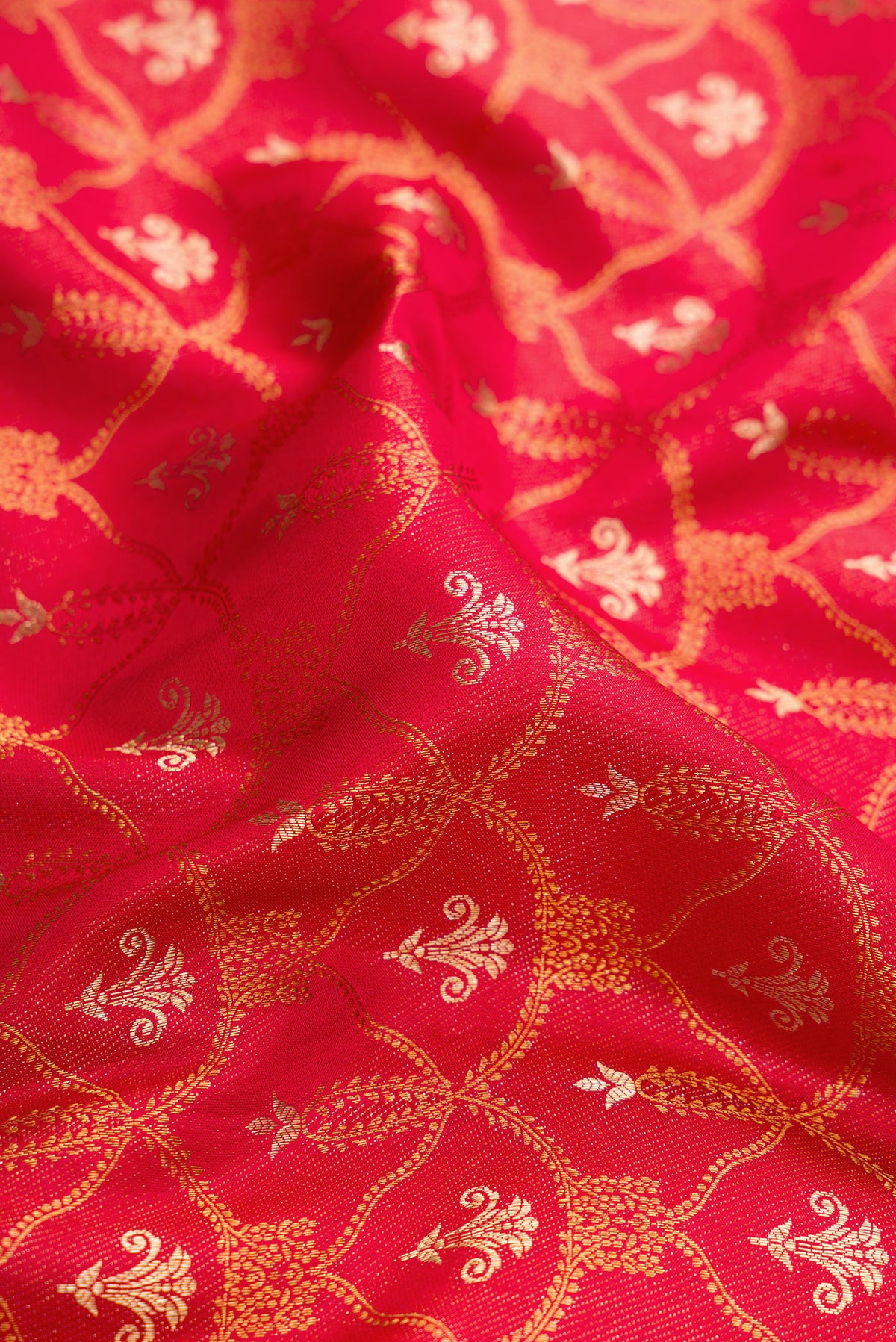 Close up of Red Dual Tone Kanjivaram Silk Saree with Zari Brocade on the body and Fancy Border.  displaying folds