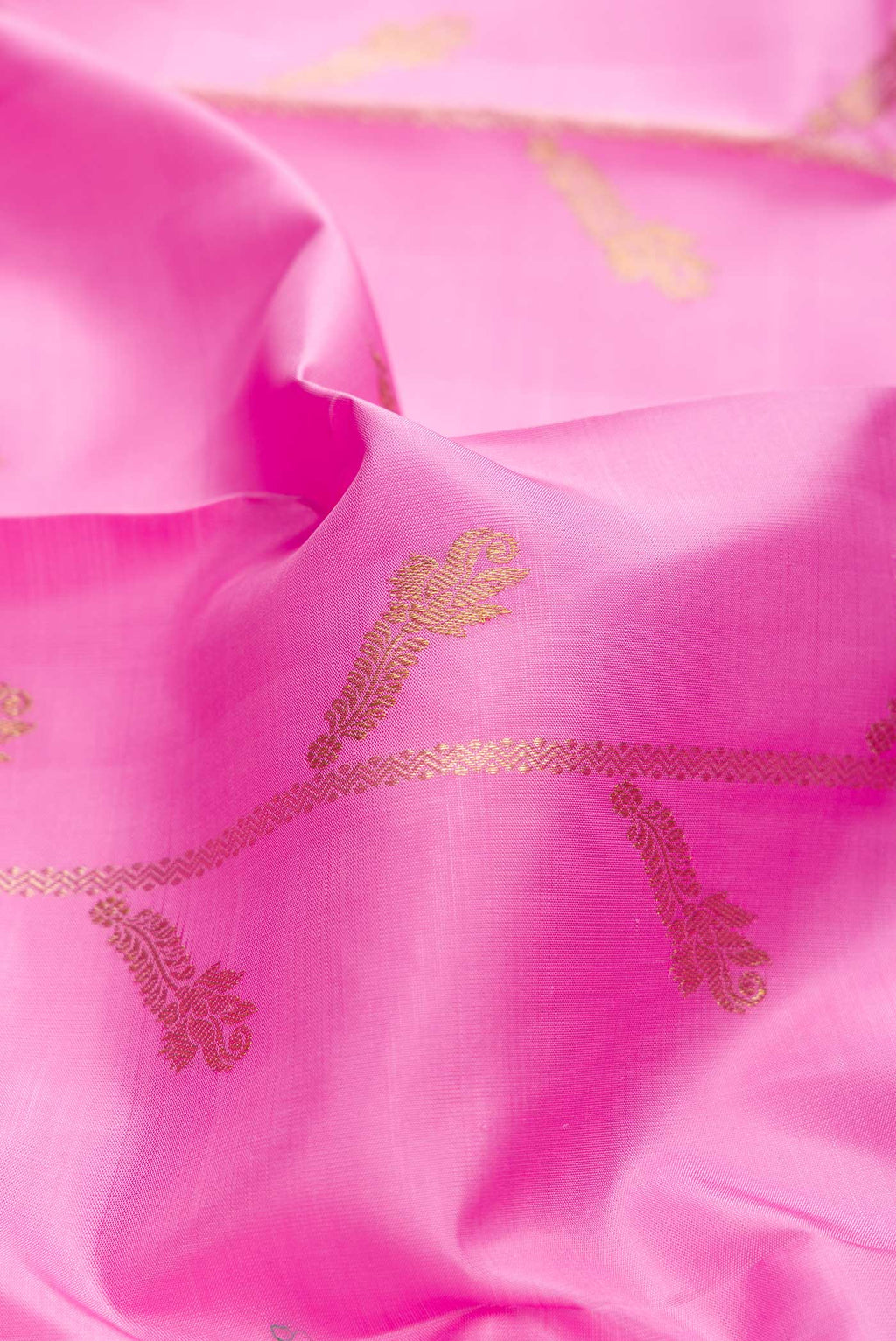 Close up of Pink Dual Tone Kanchipuram Saree with Zari Butta on the body and Zari Border displaying folds