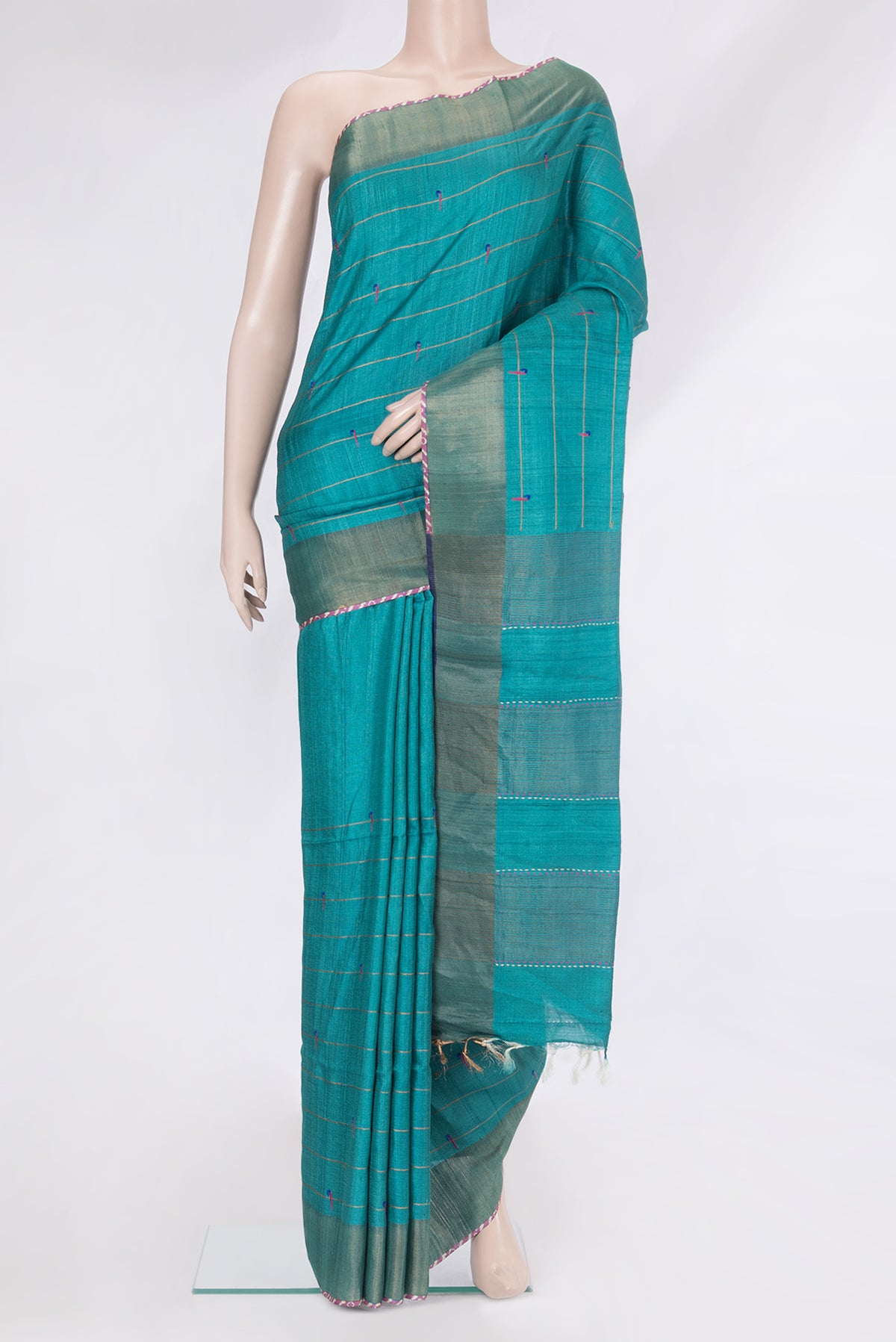 Peacock Blue Tussar Silk Saree with Checked design on the body and Zari Border.  displayed on a mannequin