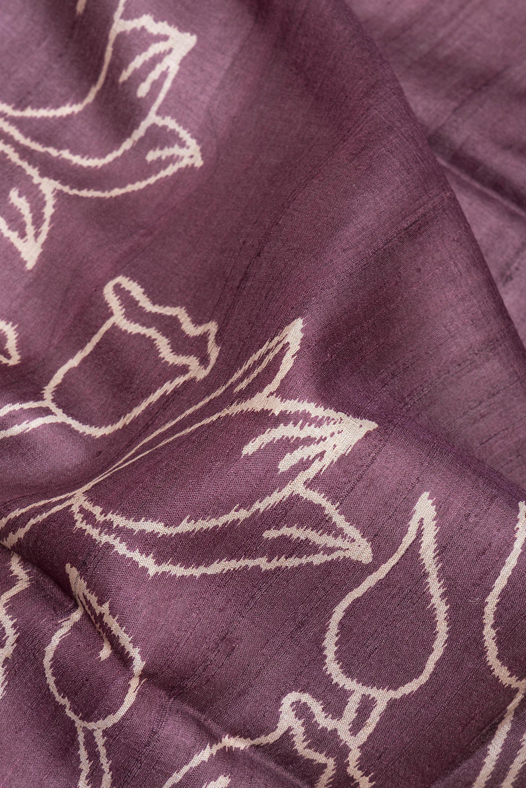 Close up of Brick Orange Tussar Saree with Printed design on the body and Zari Border.  displaying folds
