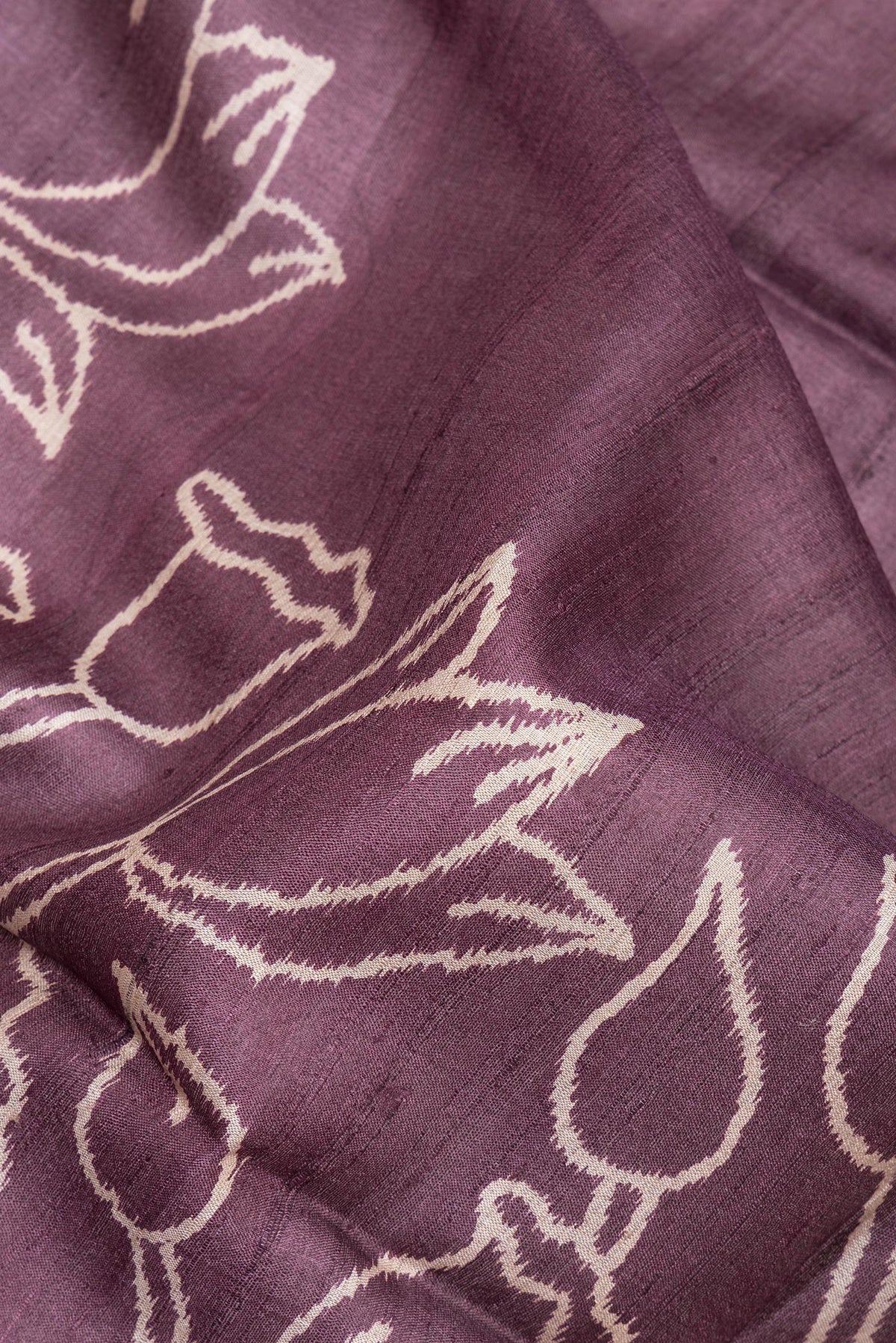 Close up of Brick Orange Tussar Saree with Printed design on the body and Zari Border.  displaying folds