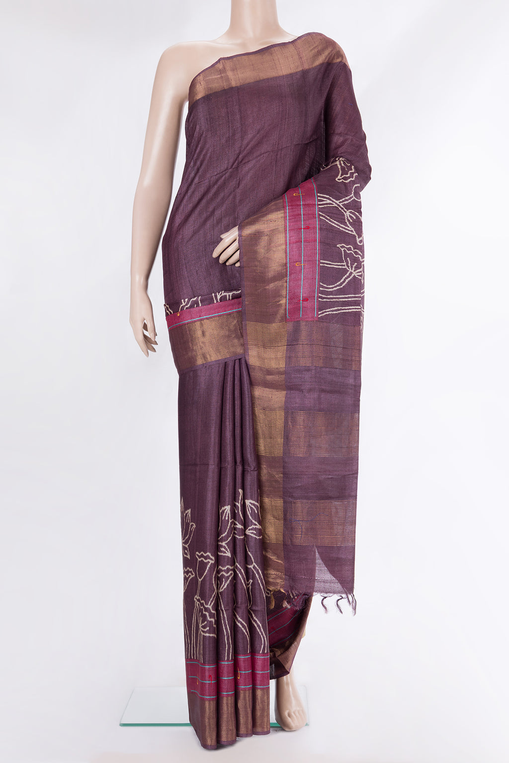 Brick Orange Tussar Saree with Printed design on the body and Zari Border.  displayed on a mannequin