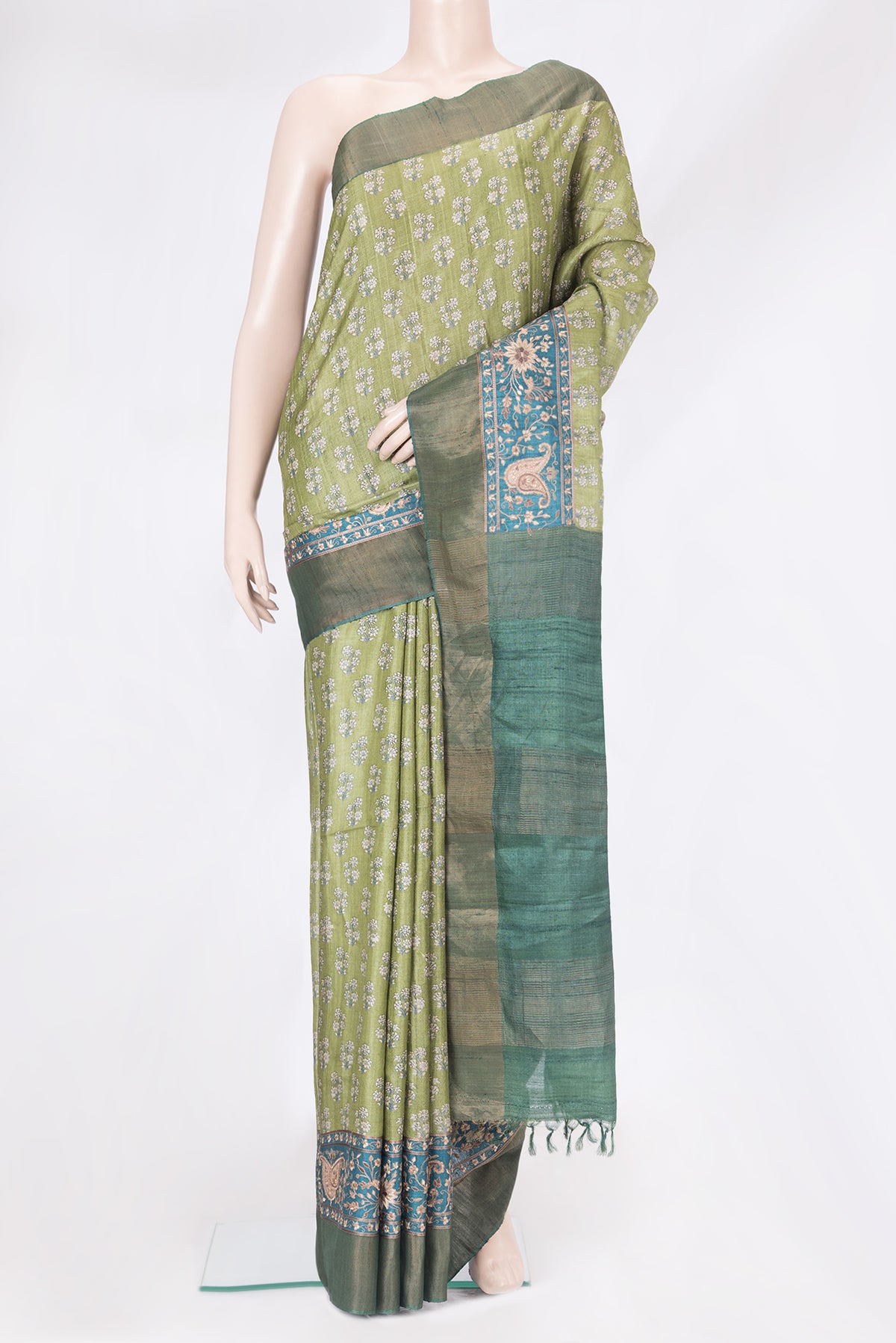 Mehandi Green Dual Tone Tussar Silk Saree with Printed design on the body and Embroidery Border.  displayed on a mannequin