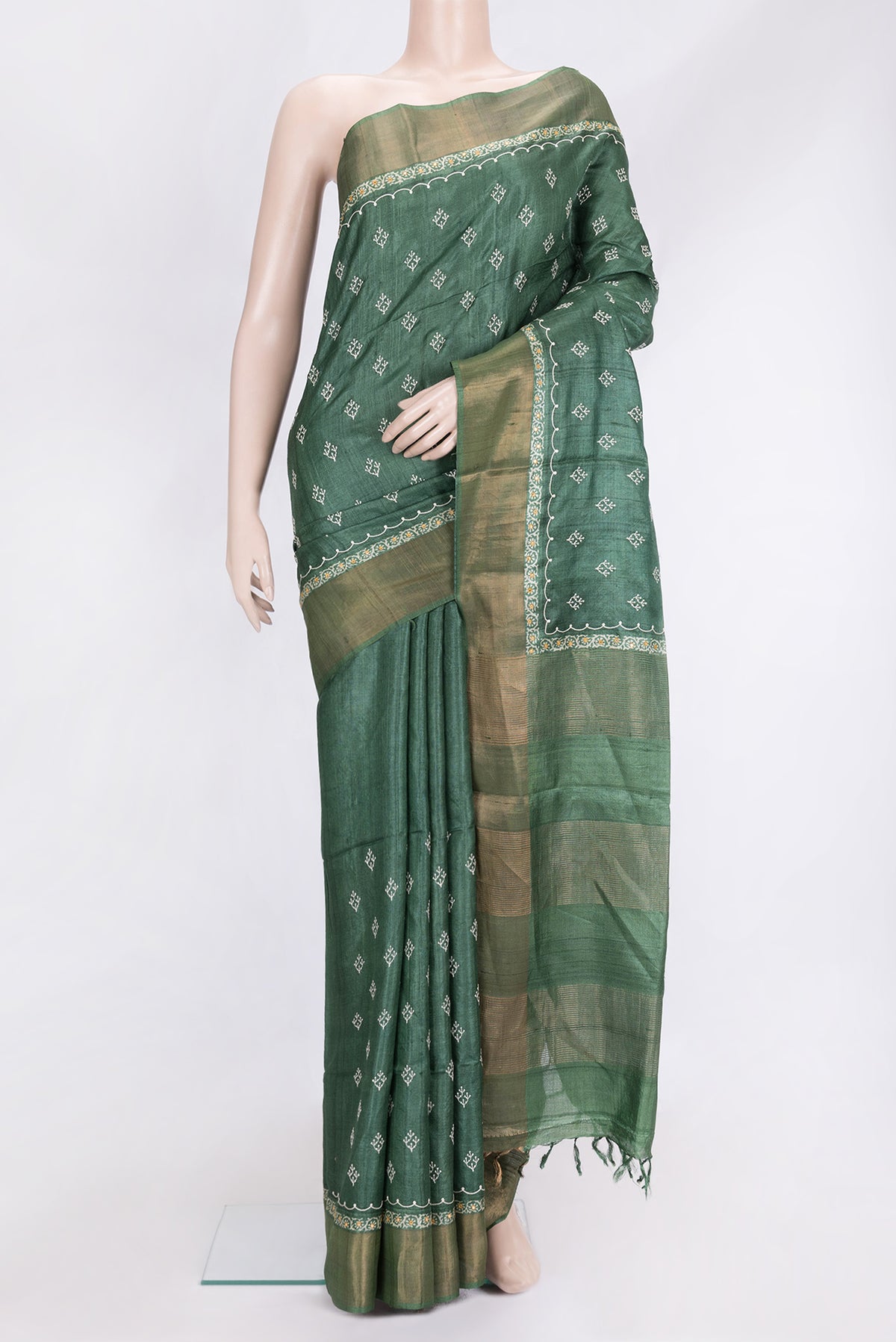 Green Dual Tone Tussar Silk Saree with Embroidery on the body and Zari Border.  displayed on a mannequin