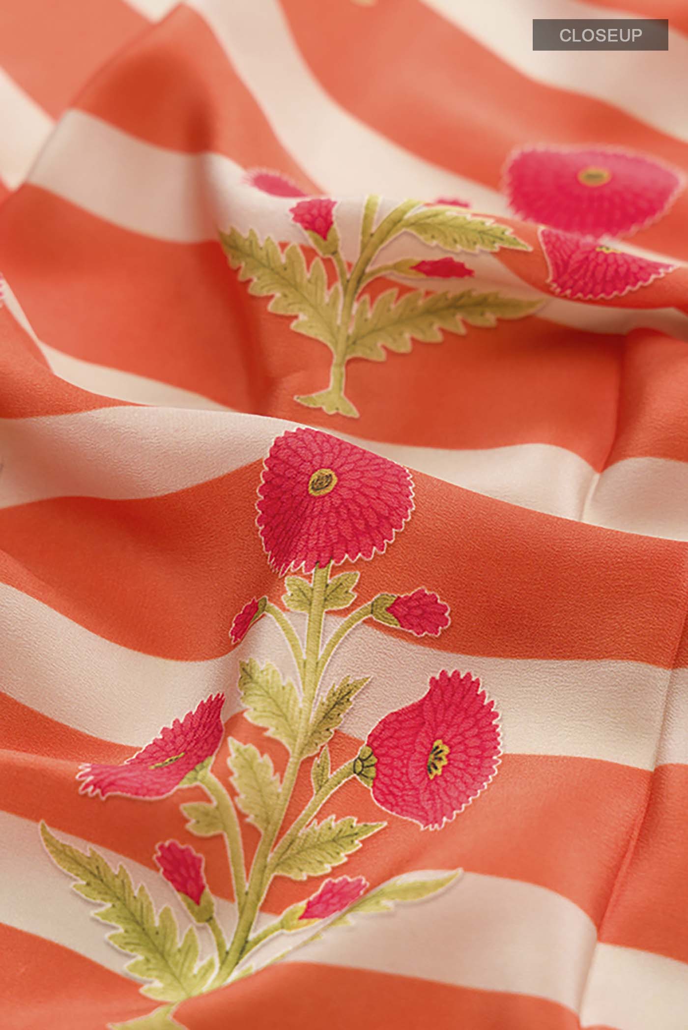 Close up of Orange Mysore Crepe Saree with Printed design on the body and Plain Border displaying folds