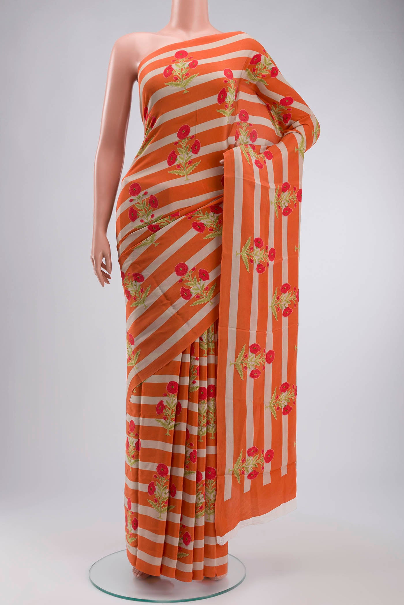 Orange Mysore Crepe Saree with Printed design on the body and Plain Border displayed on a mannequin