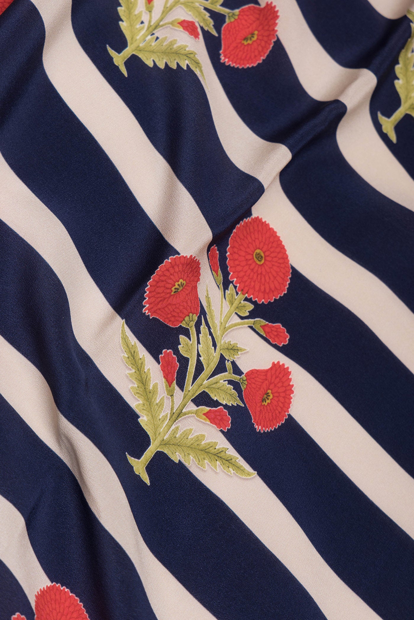 Close up of Off white and Navy Blue Color Mysore Crepe Saree with Printed design on the body and Without Border.  displaying folds