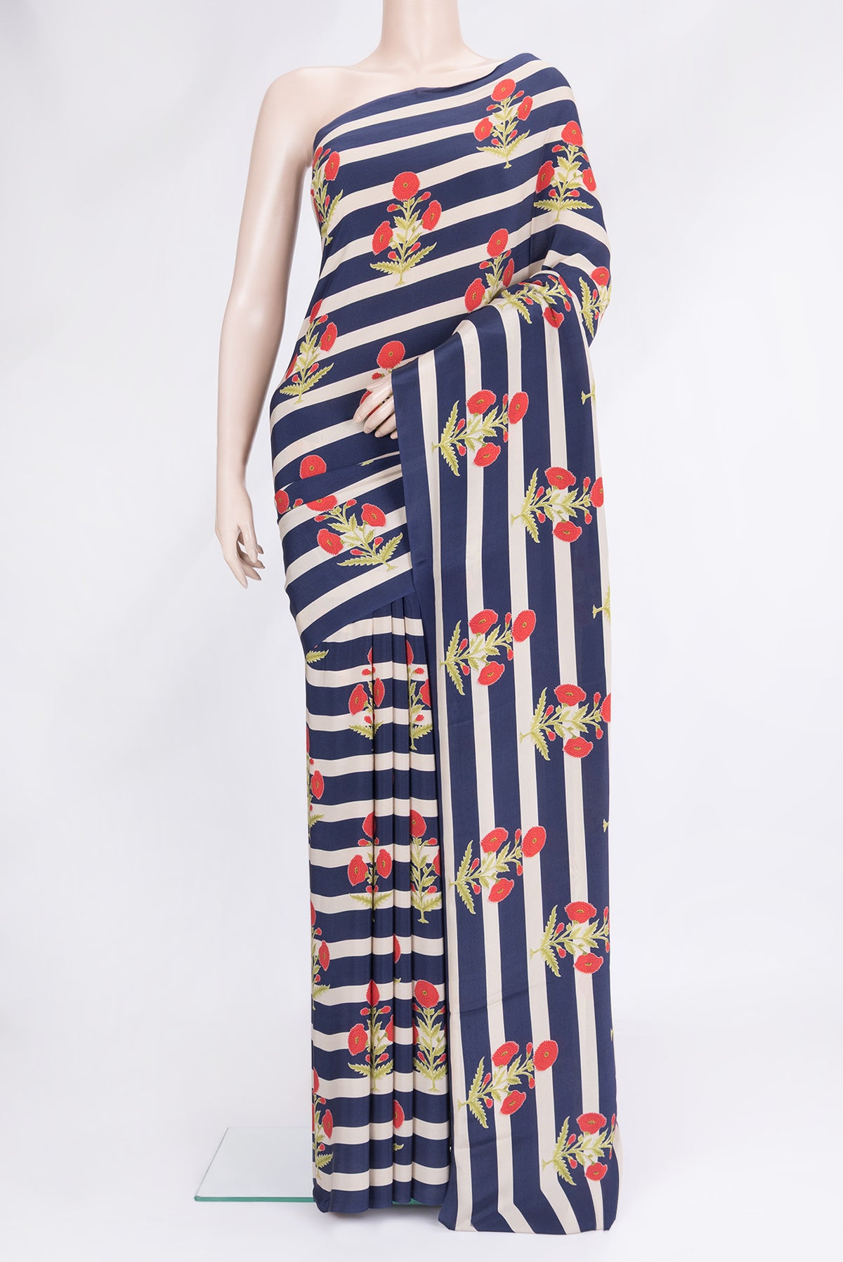 Off white and Navy Blue Color Mysore Crepe Saree with Printed design on the body and Without Border.  displayed on a mannequin