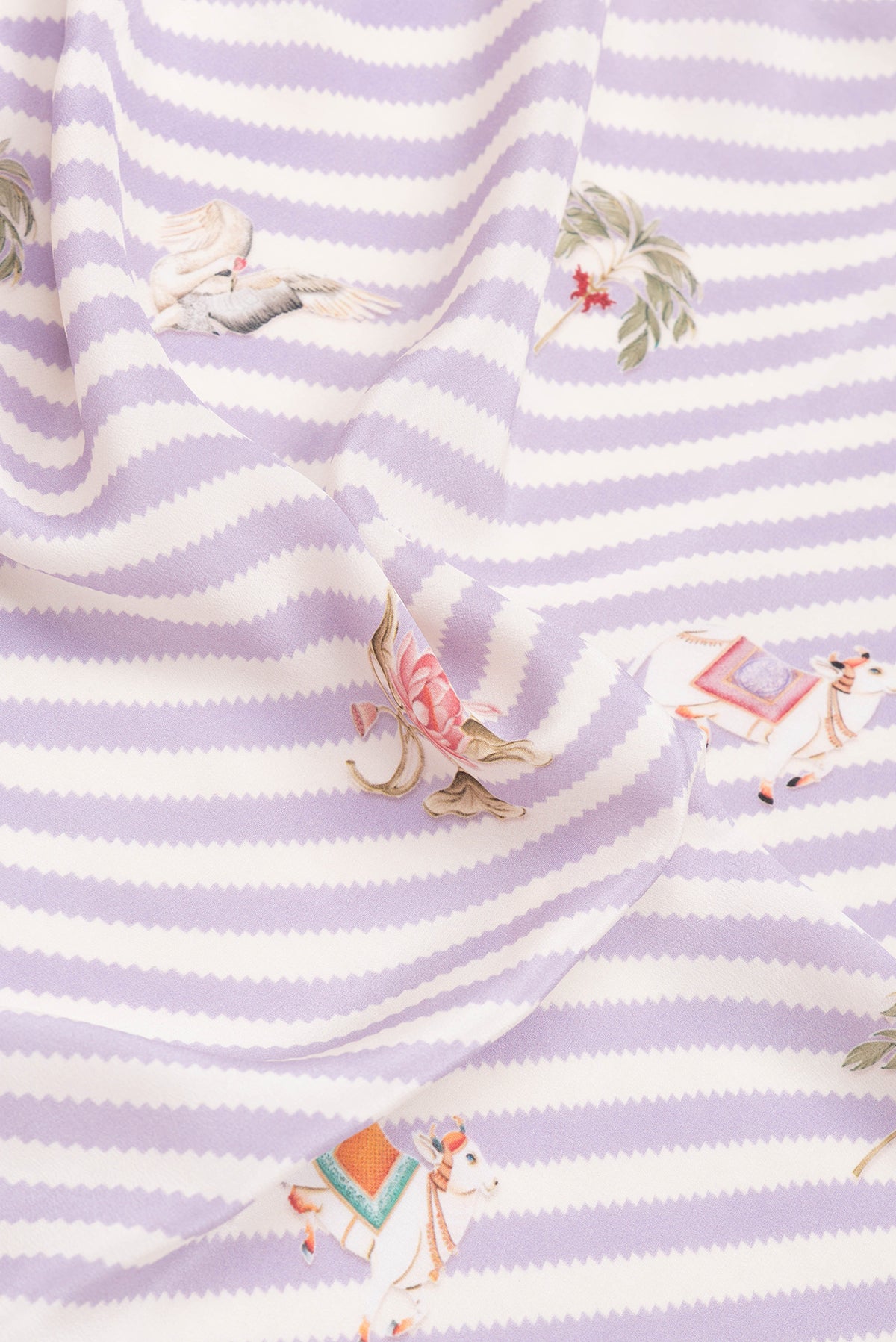 Close up of Lavender Mysore Crepe Saree with Printed design on the body and Plain Border.  displaying folds