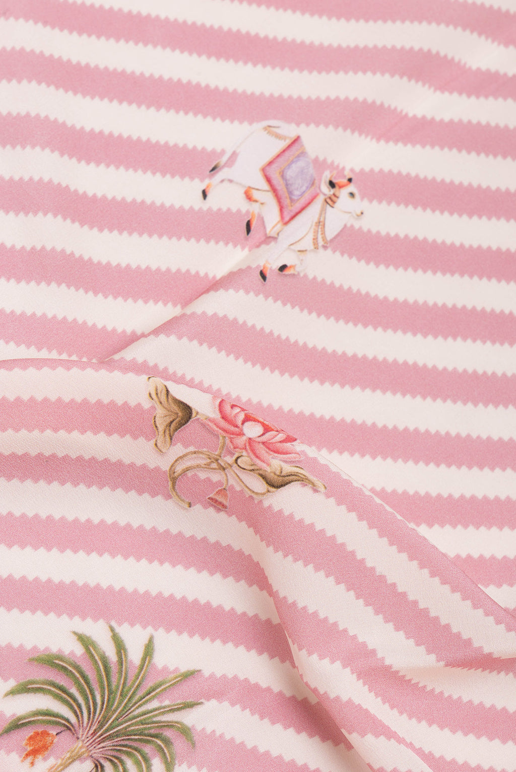 Close up of Rose pink Crepe Saree with Printed design on the body and Fancy Border.  displaying folds