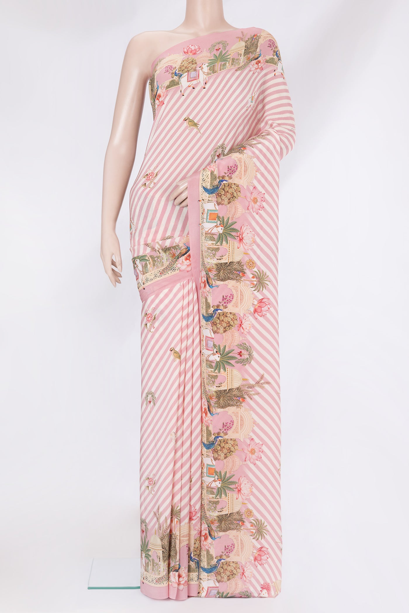 Rose pink Crepe Saree with Printed design on the body and Fancy Border.  displayed on a mannequin
