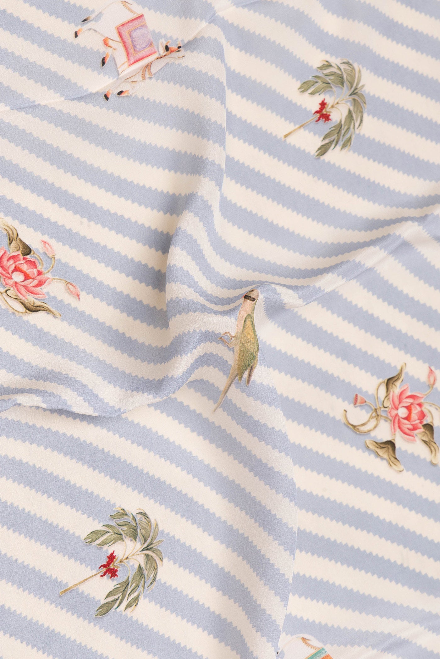 Close up of Grey Dual Tone Mysore Crepe Saree with Printed design on the body and Printed Border.  displaying folds