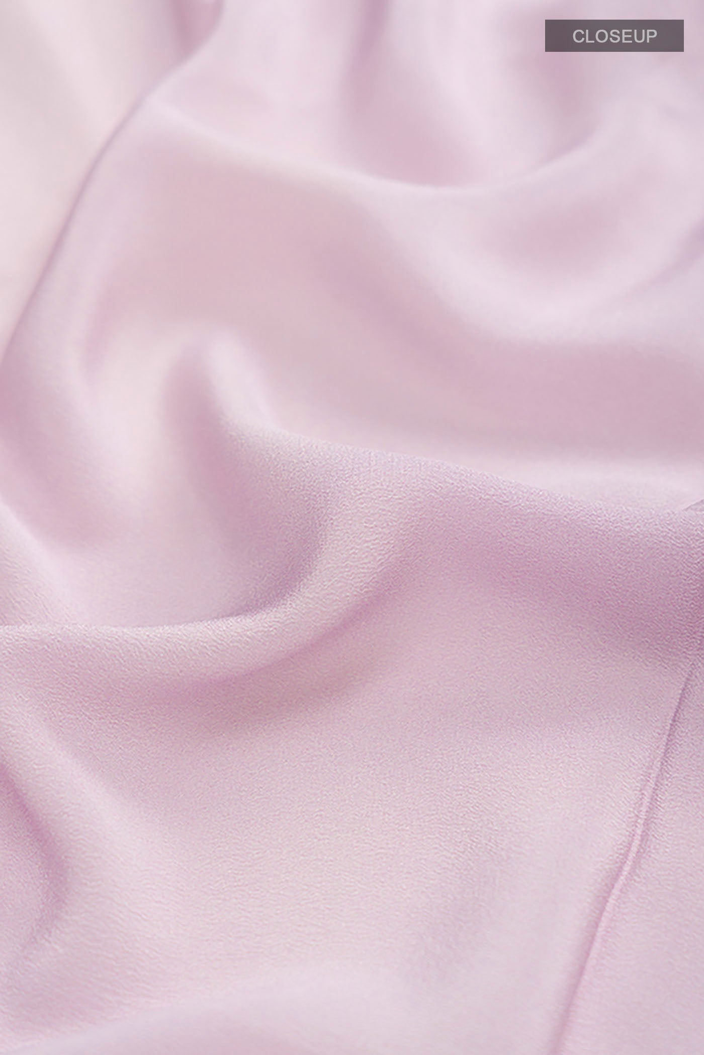 Close up of Lavender Mysore Crepe Saree with Printed design on the body and Printed Border displaying folds