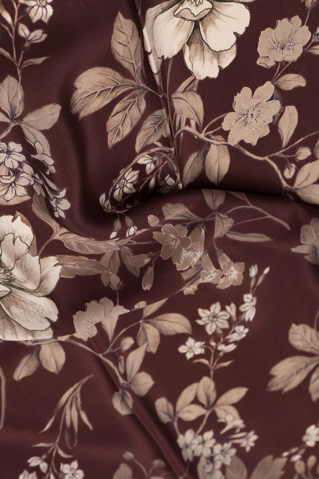 Close up of Maroon Dual Tone Mysore Crepe Saree with Printed design on the body and Without Border.  displaying folds