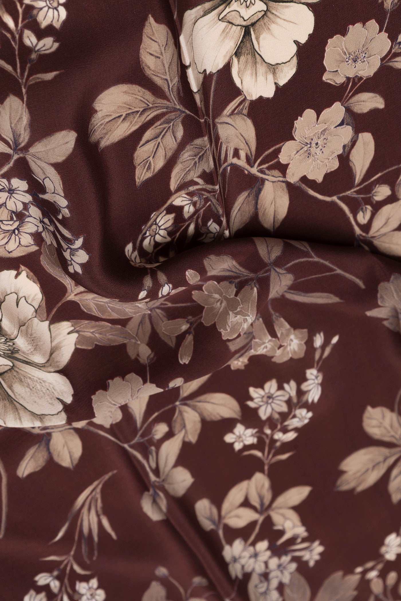 Close up of Maroon Dual Tone Mysore Crepe Saree with Printed design on the body and Without Border.  displaying folds