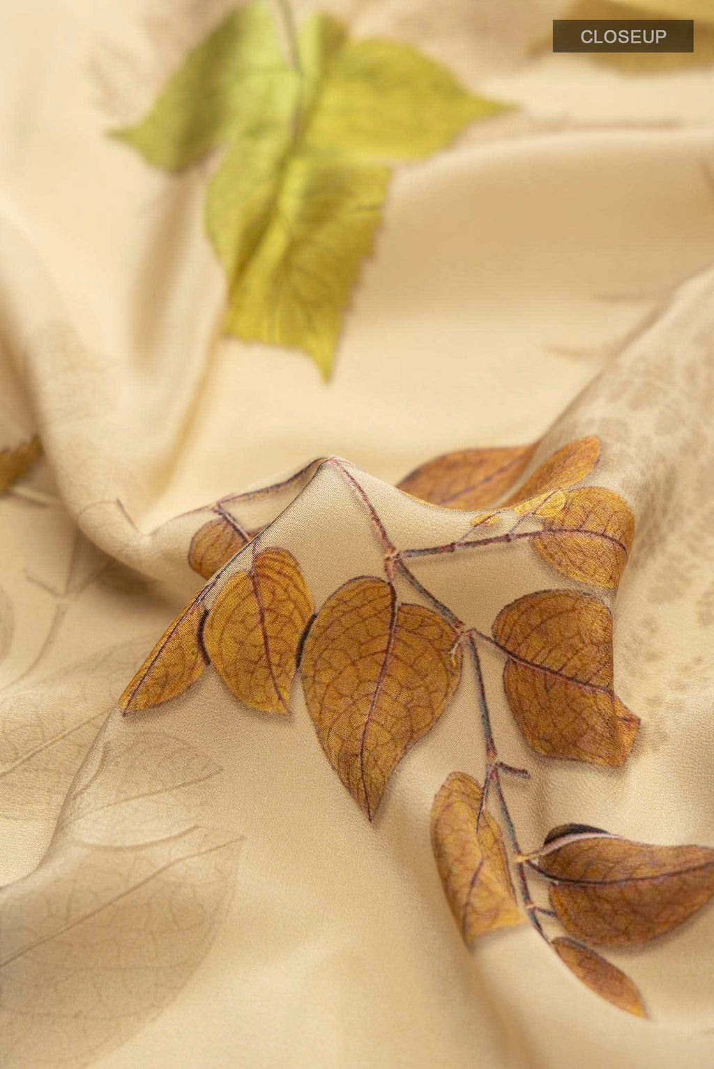 Close up of Beige Mysore Crepe Saree with Printed design on the body and Plain Border displaying folds